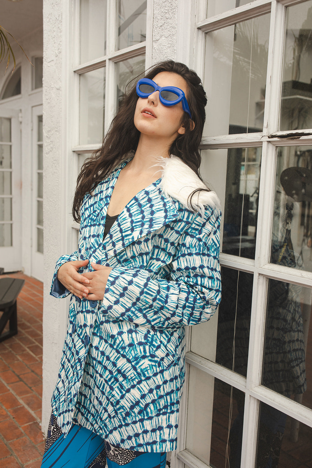 Boasting a striking aquarian color scheme on hand printed african fabric, this stylish jacket is lined with a lush blue jersey and features a removable faux fur collar.