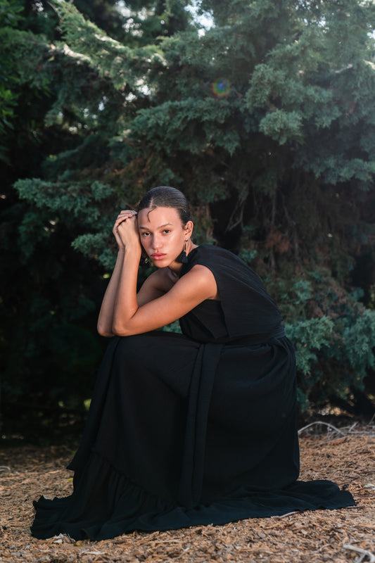 Effortlessly elegant, the Black Diamond Pleated Maxi Dress features a flattering one shoulder design with a long Obi style belt. The pleated details and shimmering sequins add texture and movement, while the flared silhouette and ruffle hem create a feminine and sophisticated look.
