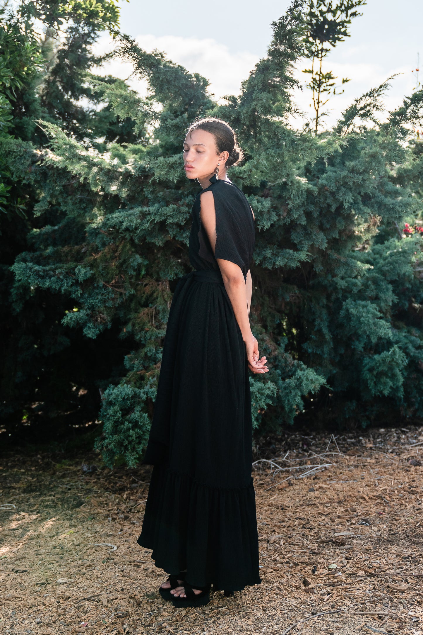 Effortlessly elegant, the Black Diamond Pleated Maxi Dress features a flattering one shoulder design with a long Obi style belt. The pleated details and shimmering sequins add texture and movement, while the flared silhouette and ruffle hem create a feminine and sophisticated look.