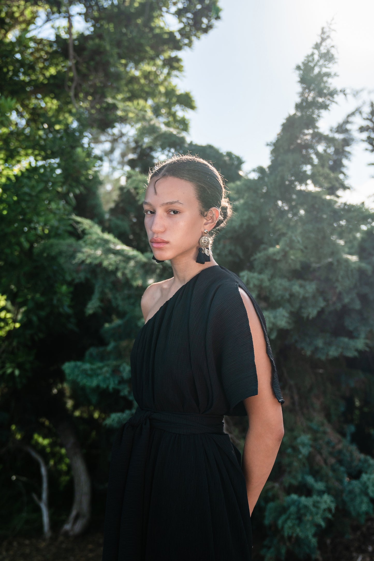 Effortlessly elegant, the Black Diamond Pleated Maxi Dress features a flattering one shoulder design with a long Obi style belt. The pleated details and shimmering sequins add texture and movement, while the flared silhouette and ruffle hem create a feminine and sophisticated look.