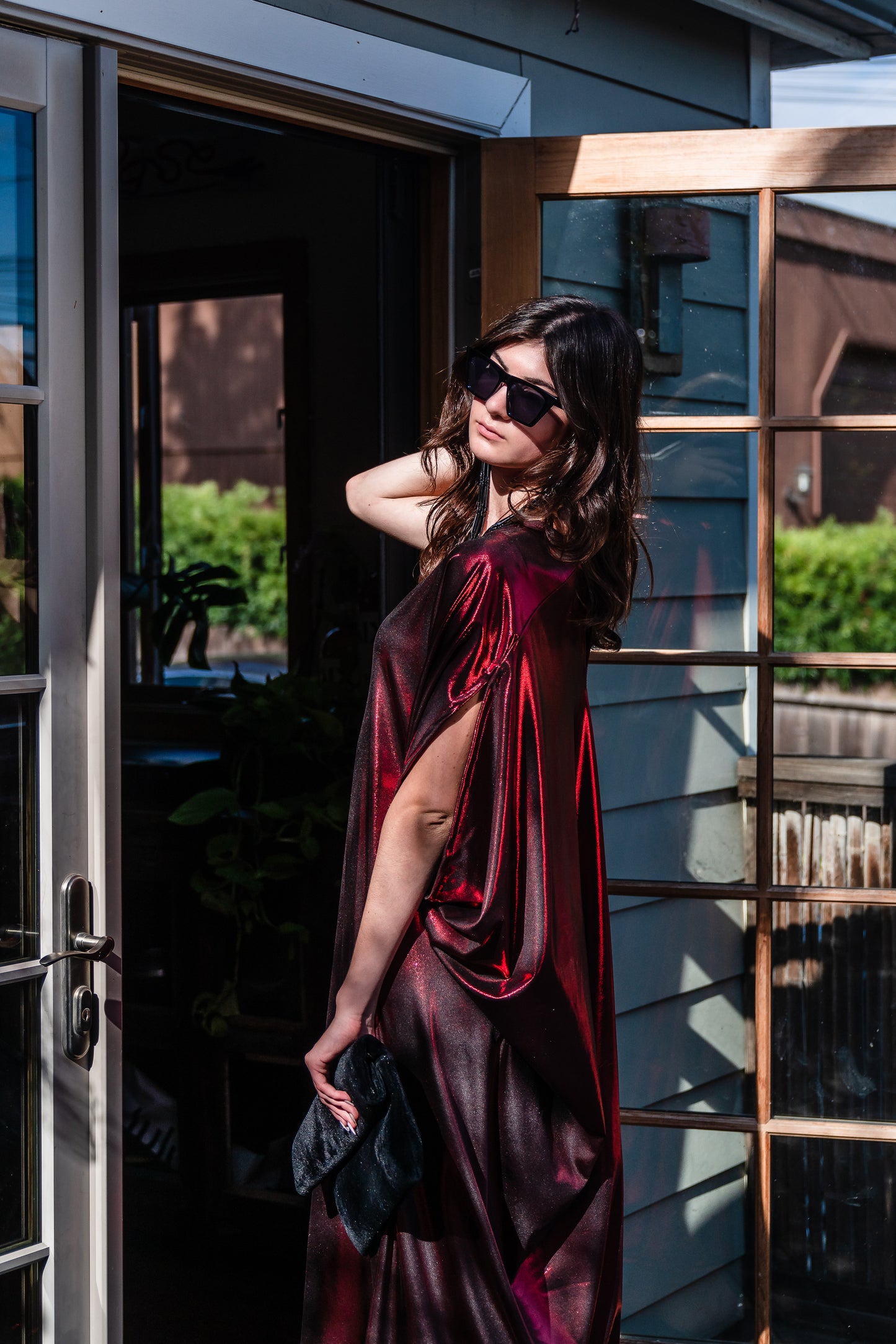 A metallic solid red caftan featuring batwing sleeves, a deep v neckline, and ankle length hem.