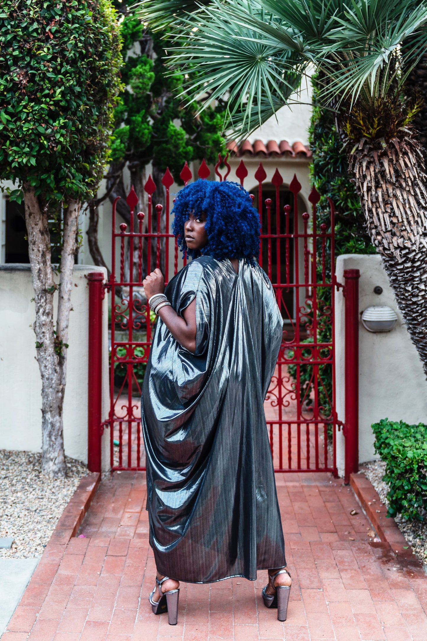 A stunning metallic caftan crafted from a slinky black jersey coated in a gorgeous mercurial foil