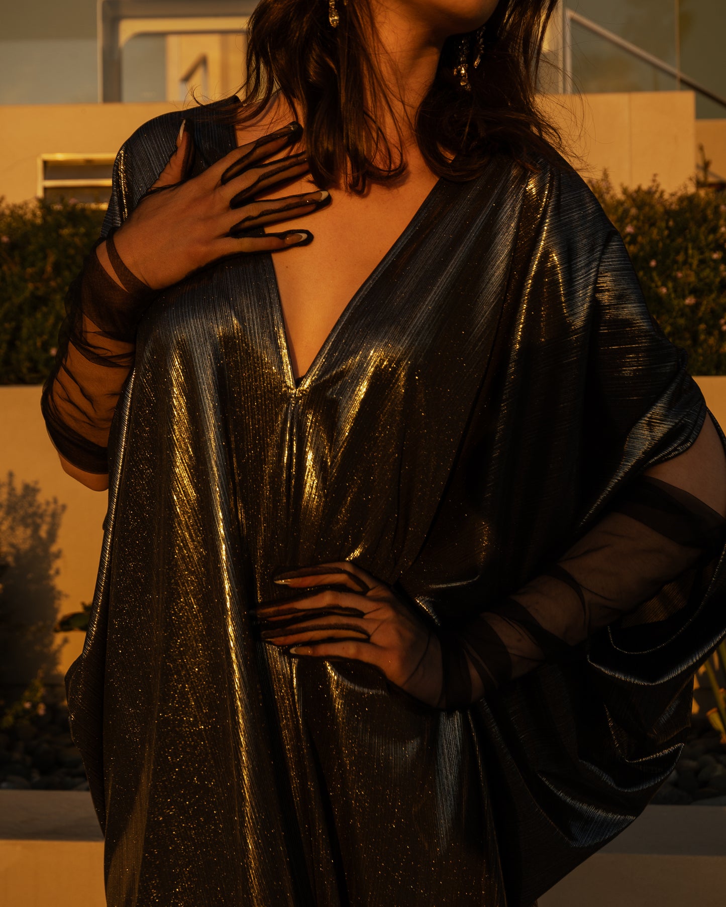 A stunning metallic caftan crafted from a slinky black jersey coated in a gorgeous mercurial foil