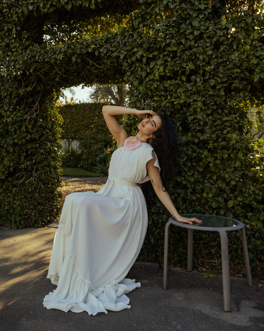 Effortlessly elegant, the Ivory Pleated Maxi Dress features a flattering one shoulder design and understated ivory. The pleated details add texture and movement, while the flared silhouette and ruffle hem create a feminine and sophisticated look.