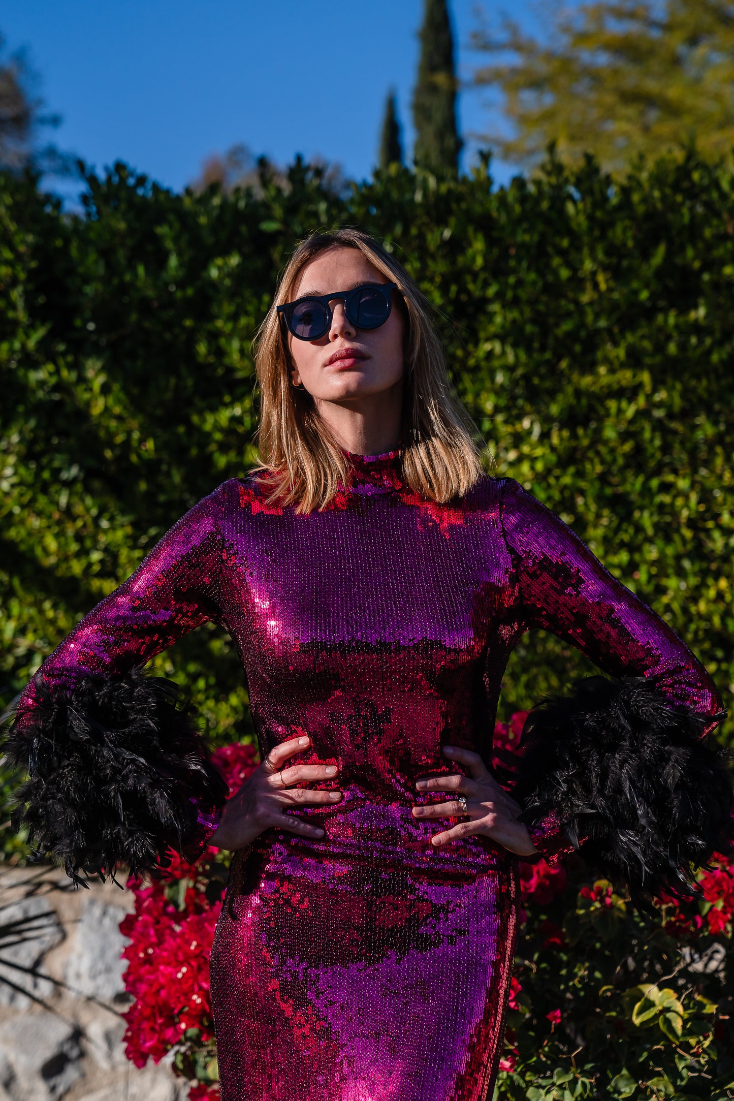 This red sequined, bodycon design accentuates your curves, while the removable feather trim on the sleeves adds a touch of elegance.