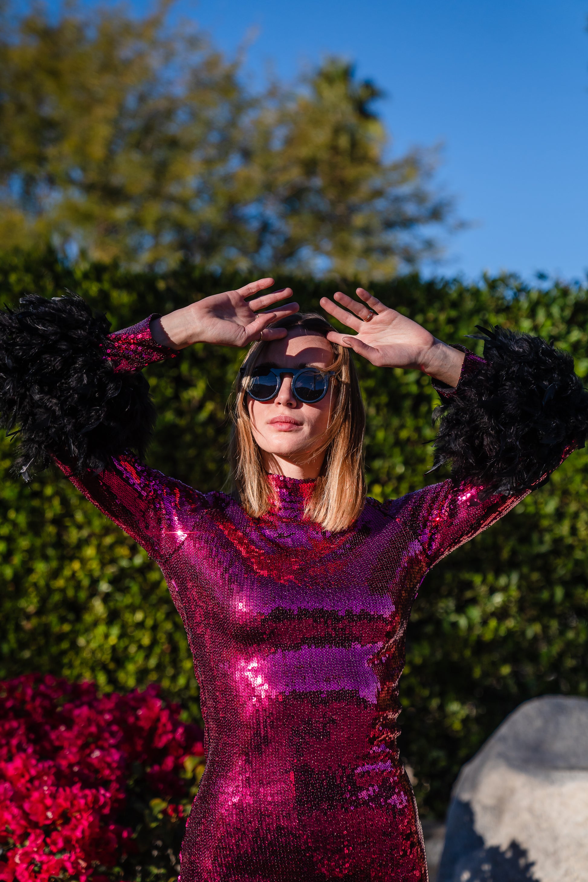 This red sequined, bodycon design accentuates your curves, while the removable feather trim on the sleeves adds a touch of elegance.
