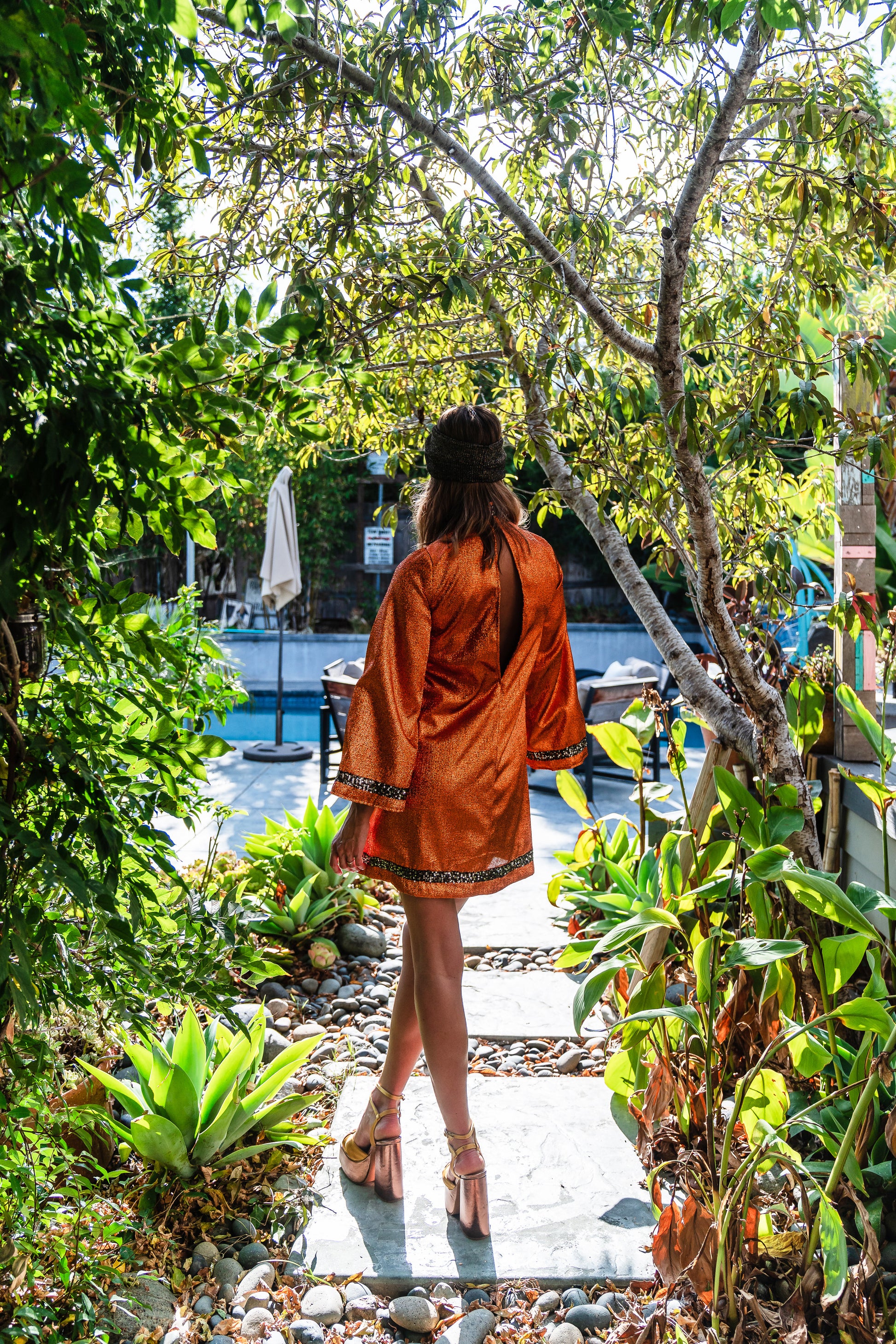 Crafted from a shimmering, fiery orange fabric embellished with an intricate sequin sun and matching sequin details at collar, cuffs, and hem, this is the bold and dreamy 60s revival romance dress every wardrobe craves