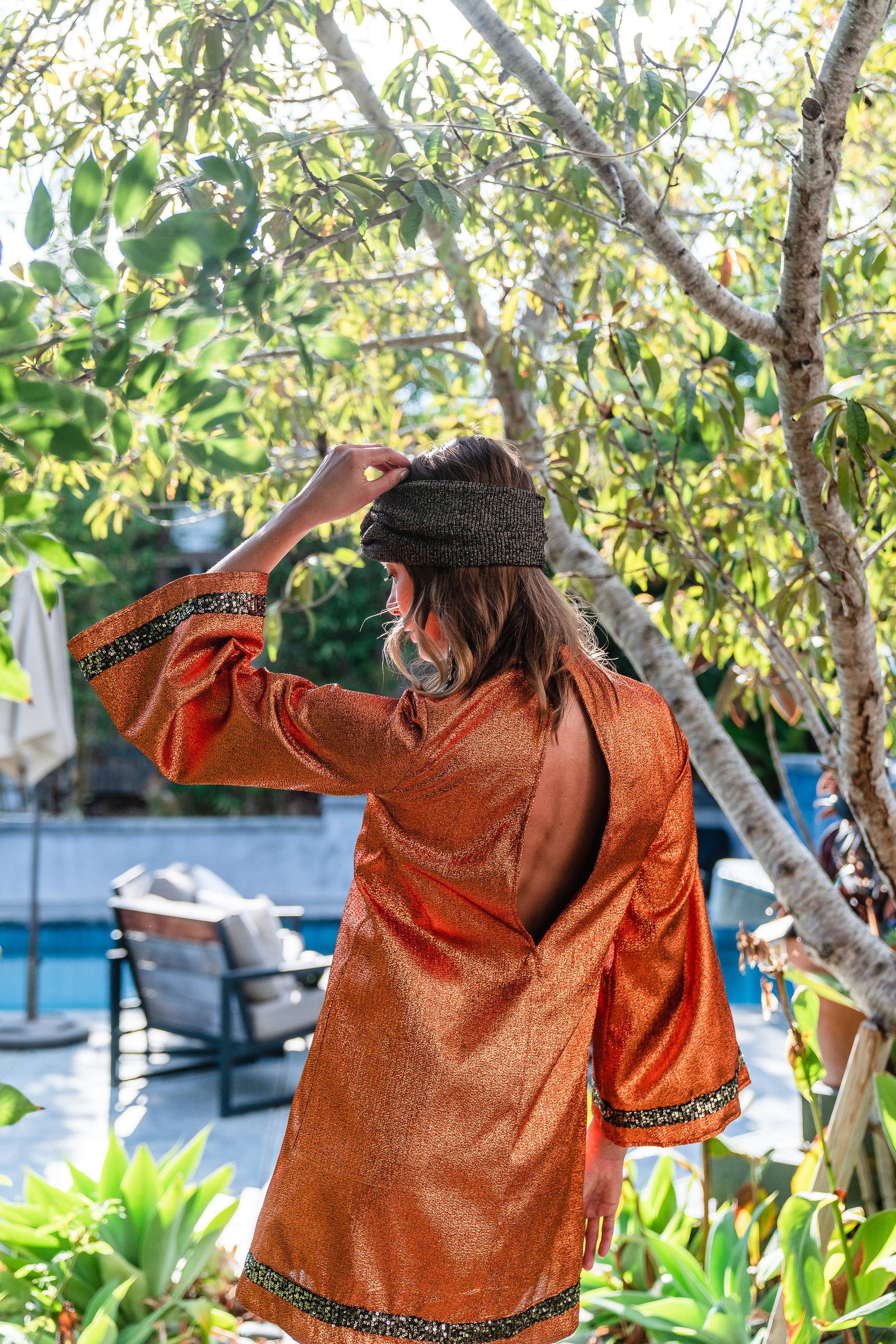 Crafted from a shimmering, fiery orange fabric embellished with an intricate sequin sun and matching sequin details at collar, cuffs, and hem, this is the bold and dreamy 60s revival romance dress every wardrobe craves