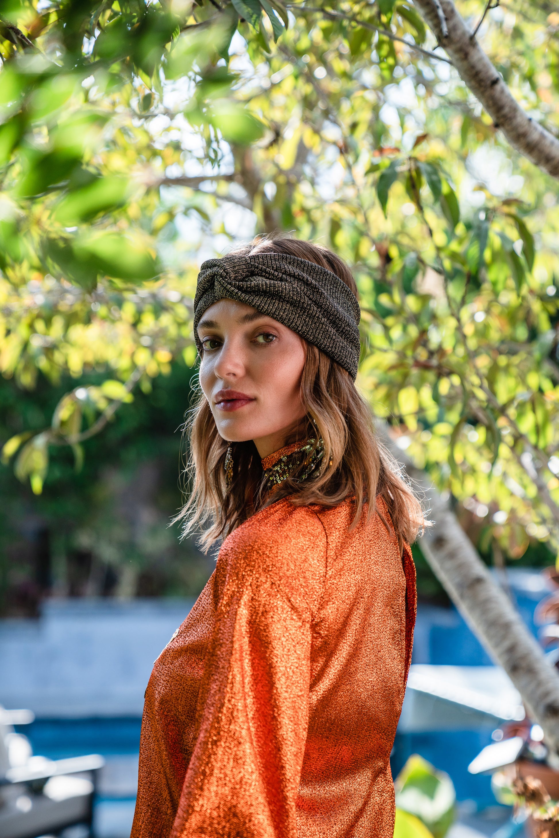 Crafted from a shimmering, fiery orange fabric embellished with an intricate sequin sun and matching sequin details at collar, cuffs, and hem, this is the bold and dreamy 60s revival romance dress every wardrobe craves