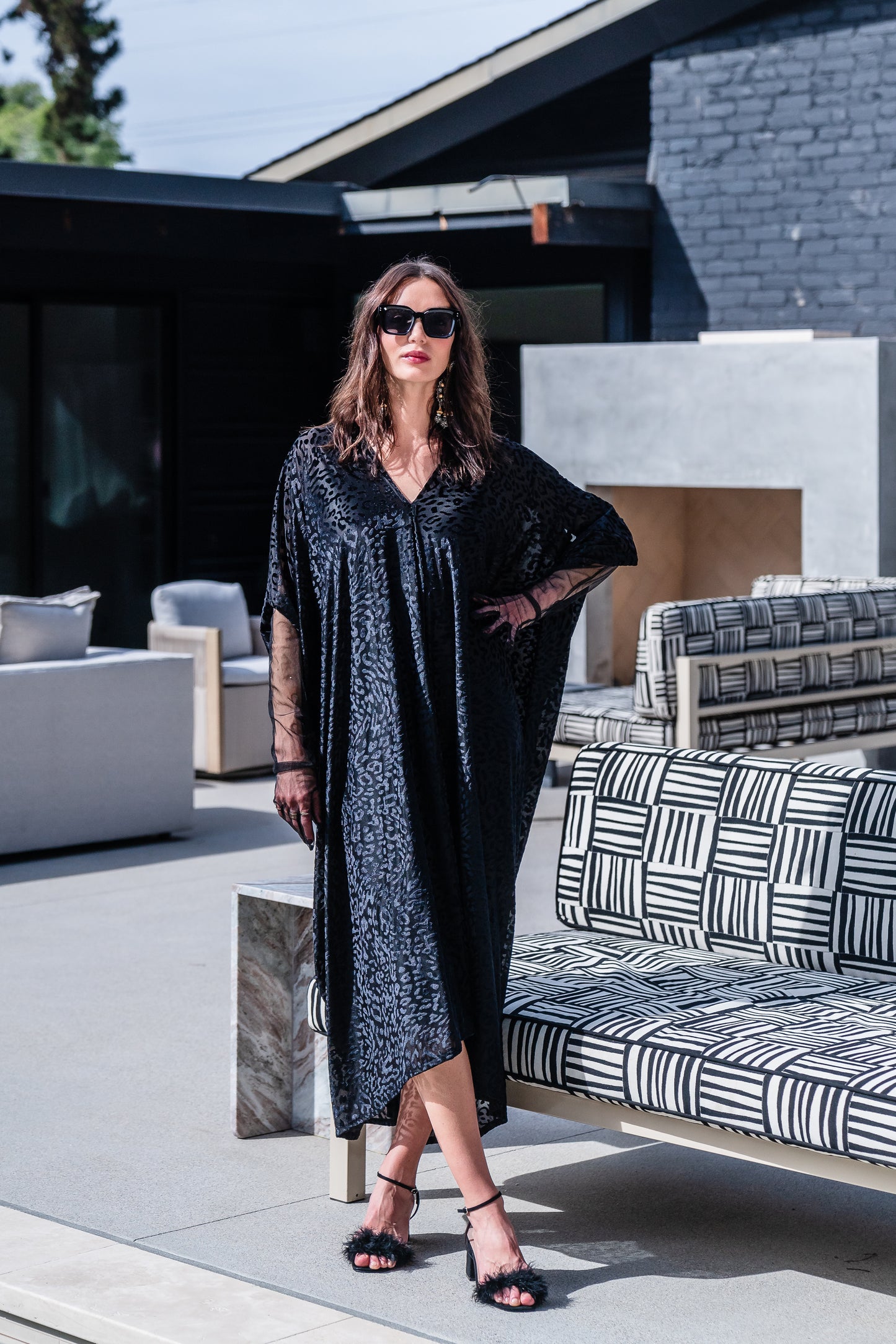 This caftan is made from a black rayon burn out velvet fabric and features leopard print pattern, deep v neckline, batwing sleeves, and ankle length hem.