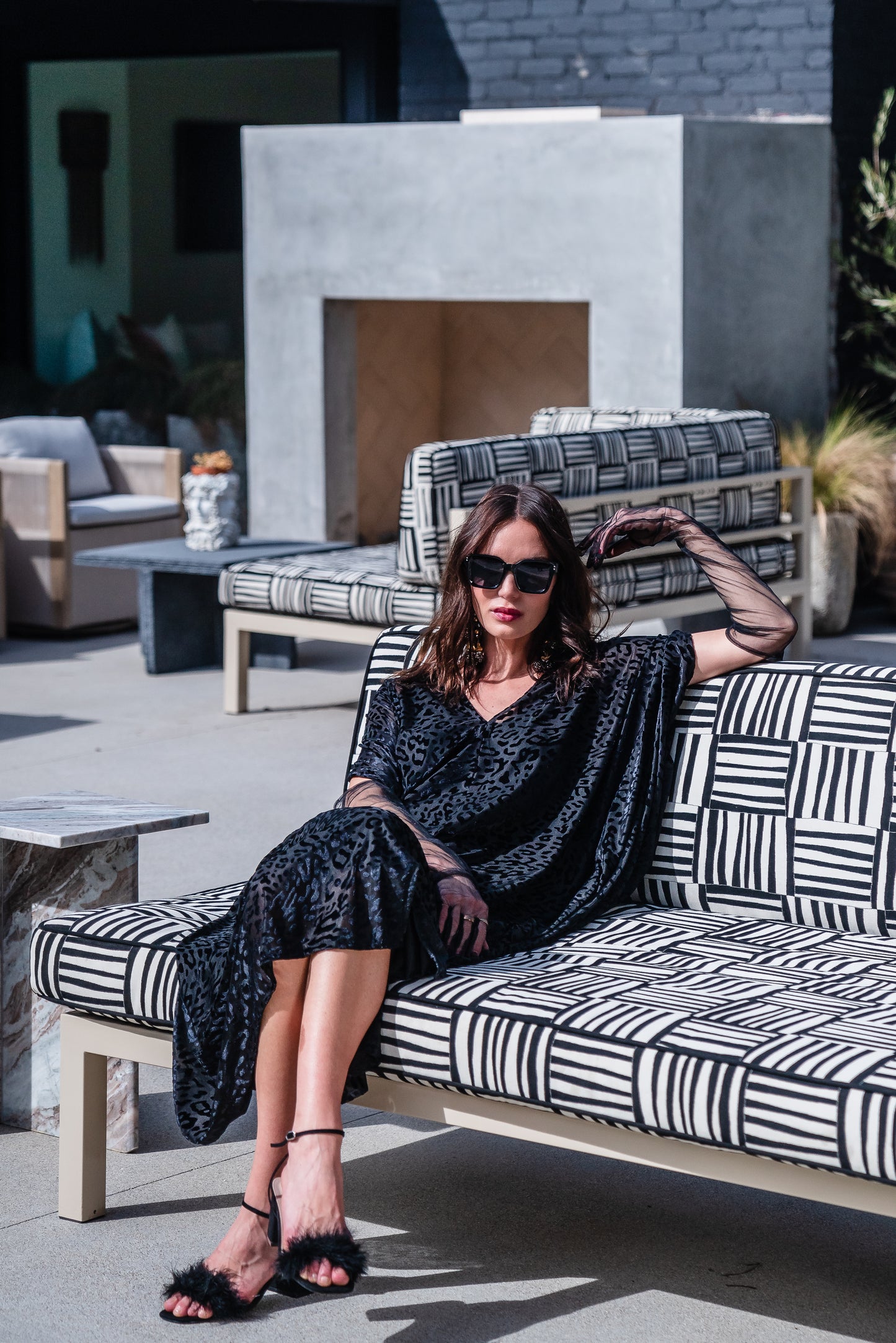 This caftan is made from a black rayon burn out velvet fabric and features leopard print pattern, deep v neckline, batwing sleeves, and ankle length hem.