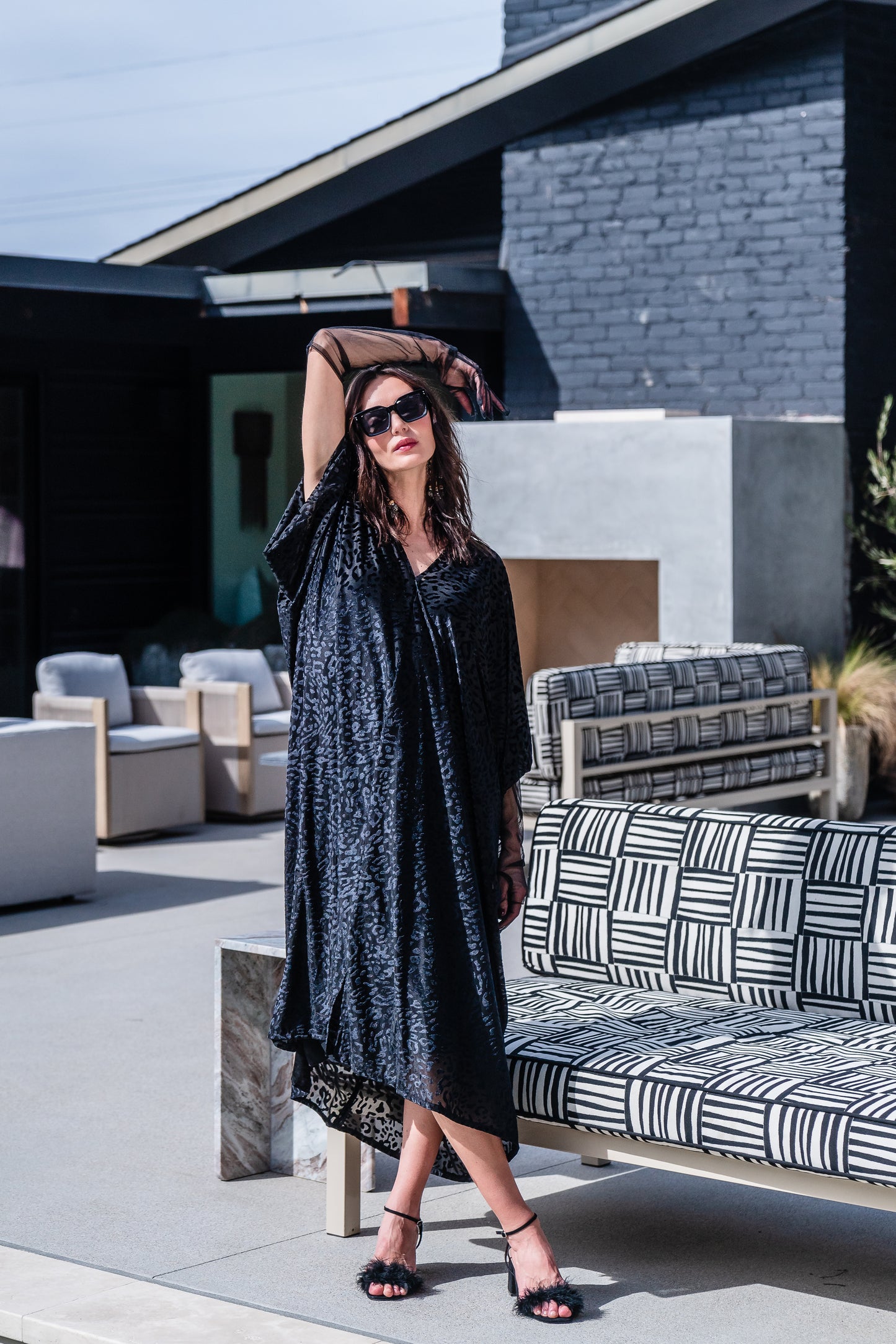 This caftan is made from a black rayon burn out velvet fabric and features leopard print pattern, deep v neckline, batwing sleeves, and ankle length hem.