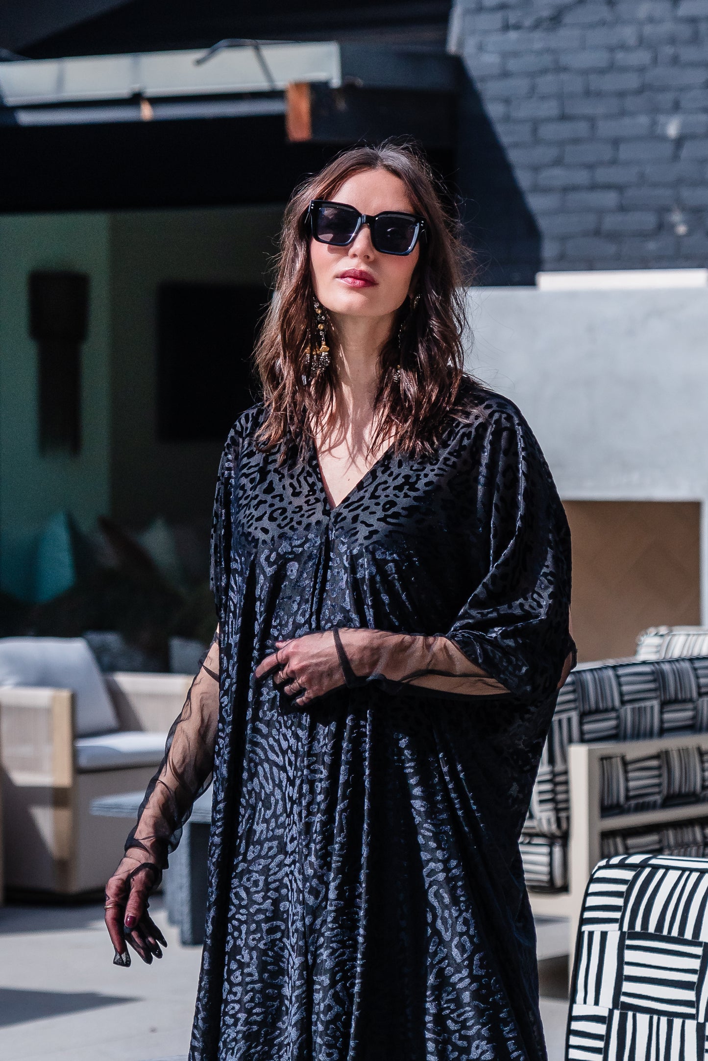 This caftan is made from a black rayon burn out velvet fabric and features leopard print pattern, deep v neckline, batwing sleeves, and ankle length hem.