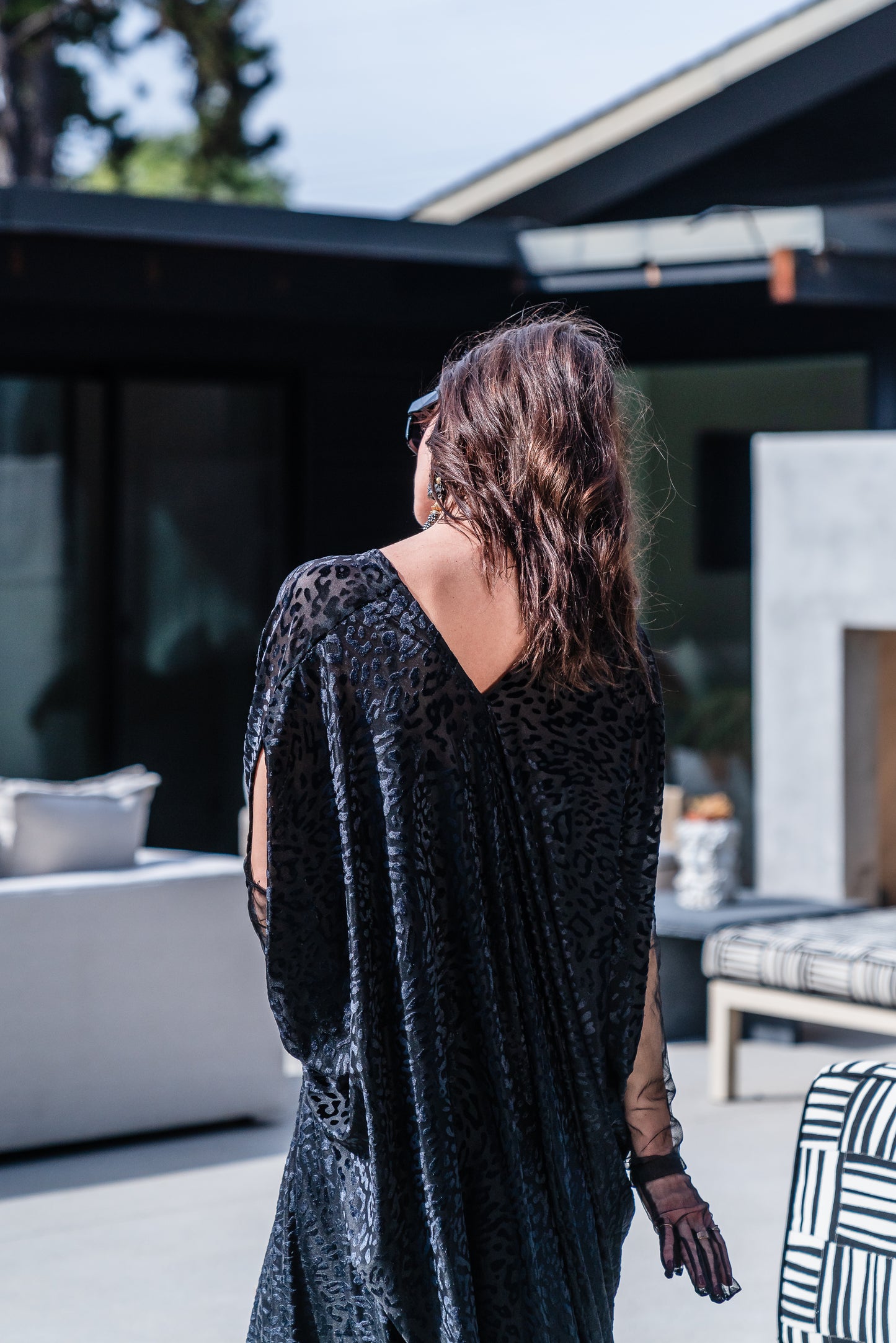 This caftan is made from a black rayon burn out velvet fabric and features leopard print pattern, deep v neckline, batwing sleeves, and ankle length hem.