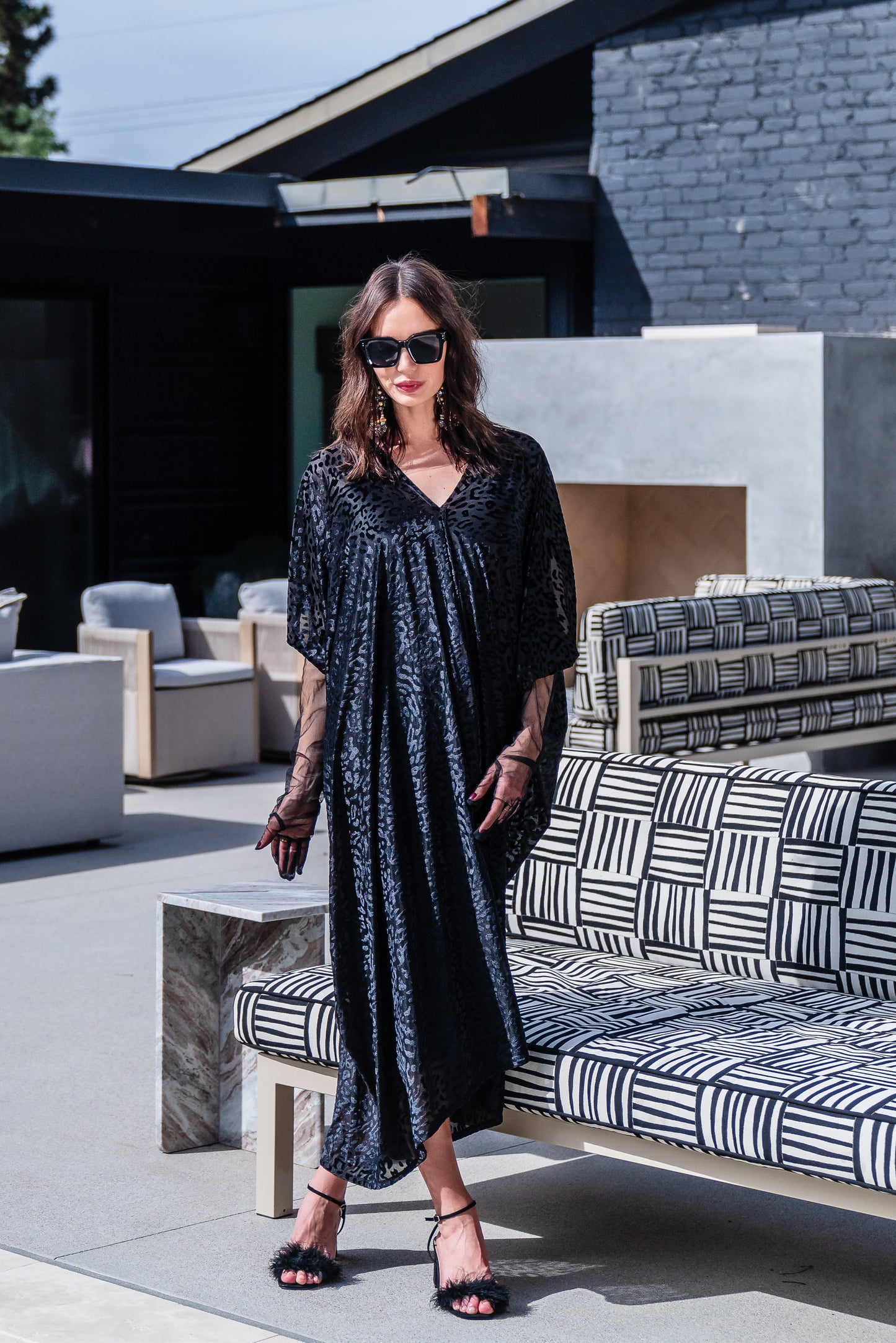 This caftan is made from a black rayon burn out velvet fabric and features leopard print pattern, deep v neckline, batwing sleeves, and ankle length hem.
