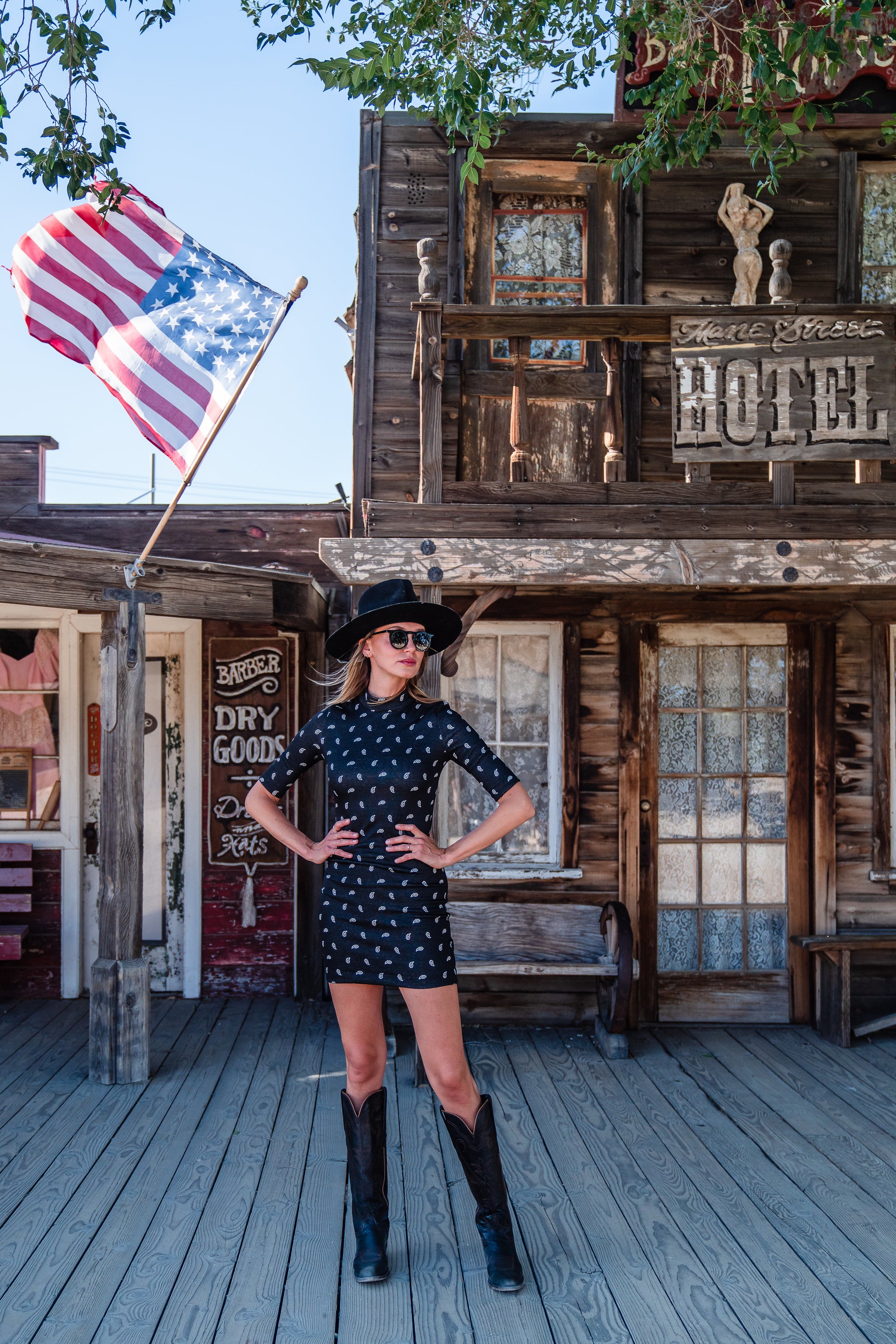 This Jennafer Grace mini dress features a black and white paisley print, elbow length short sleeves, a mock neck, and invisible zipper in back.