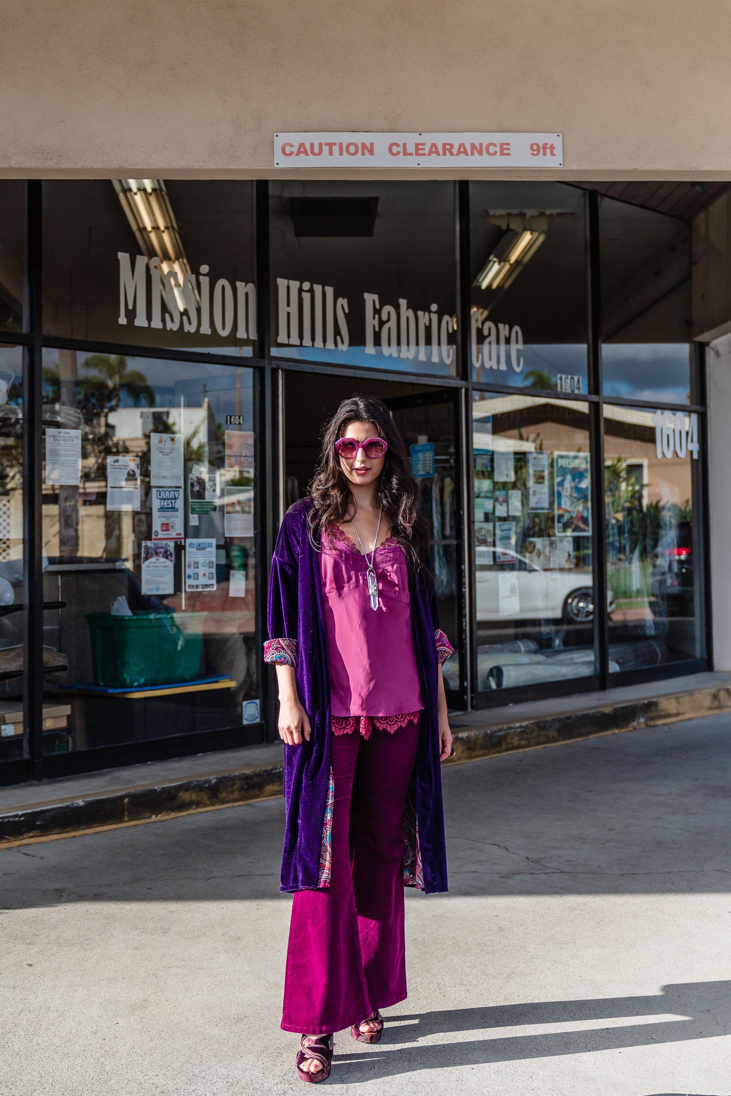 Reversible purple velvet knee length kimono with narrow sleeves, it has tie belt at the waist, the lining is pink and purple paisley printed chiffon, lining is shown at the turned up cuffs