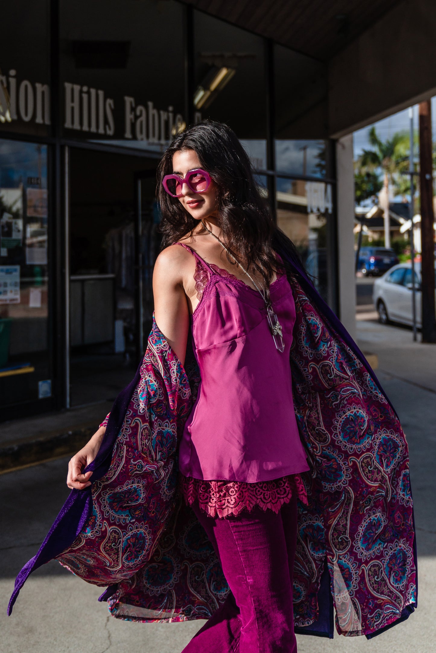 Reversible purple velvet knee length kimono with narrow sleeves, it has tie belt at the waist, the lining is pink and purple paisley printed chiffon, lining is shown at the turned up cuffs