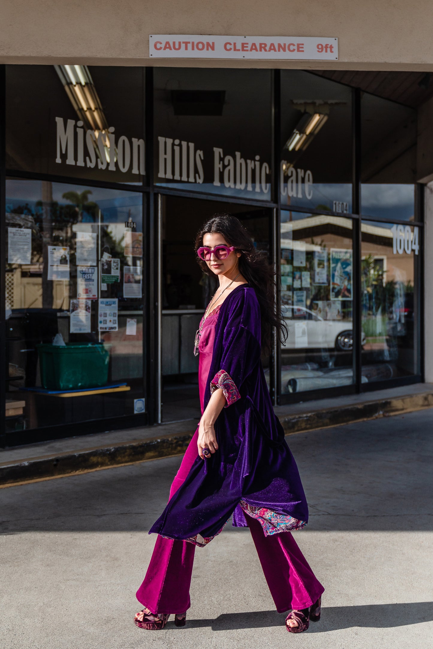 Reversible purple velvet knee length kimono with narrow sleeves, it has tie belt at the waist, the lining is pink and purple paisley printed chiffon, lining is shown at the turned up cuffs