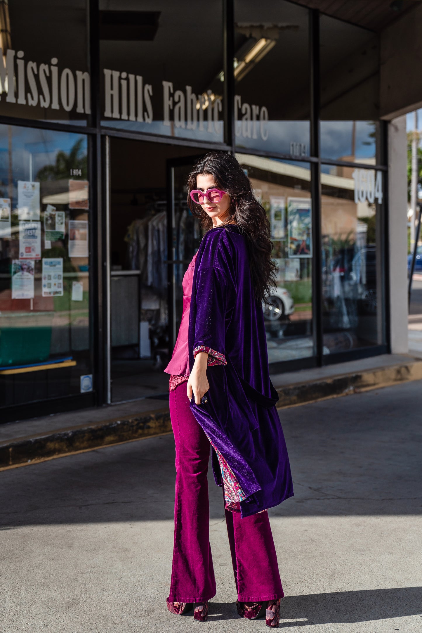 Reversible purple velvet knee length kimono with narrow sleeves, it has tie belt at the waist, the lining is pink and purple paisley printed chiffon, lining is shown at the turned up cuffs