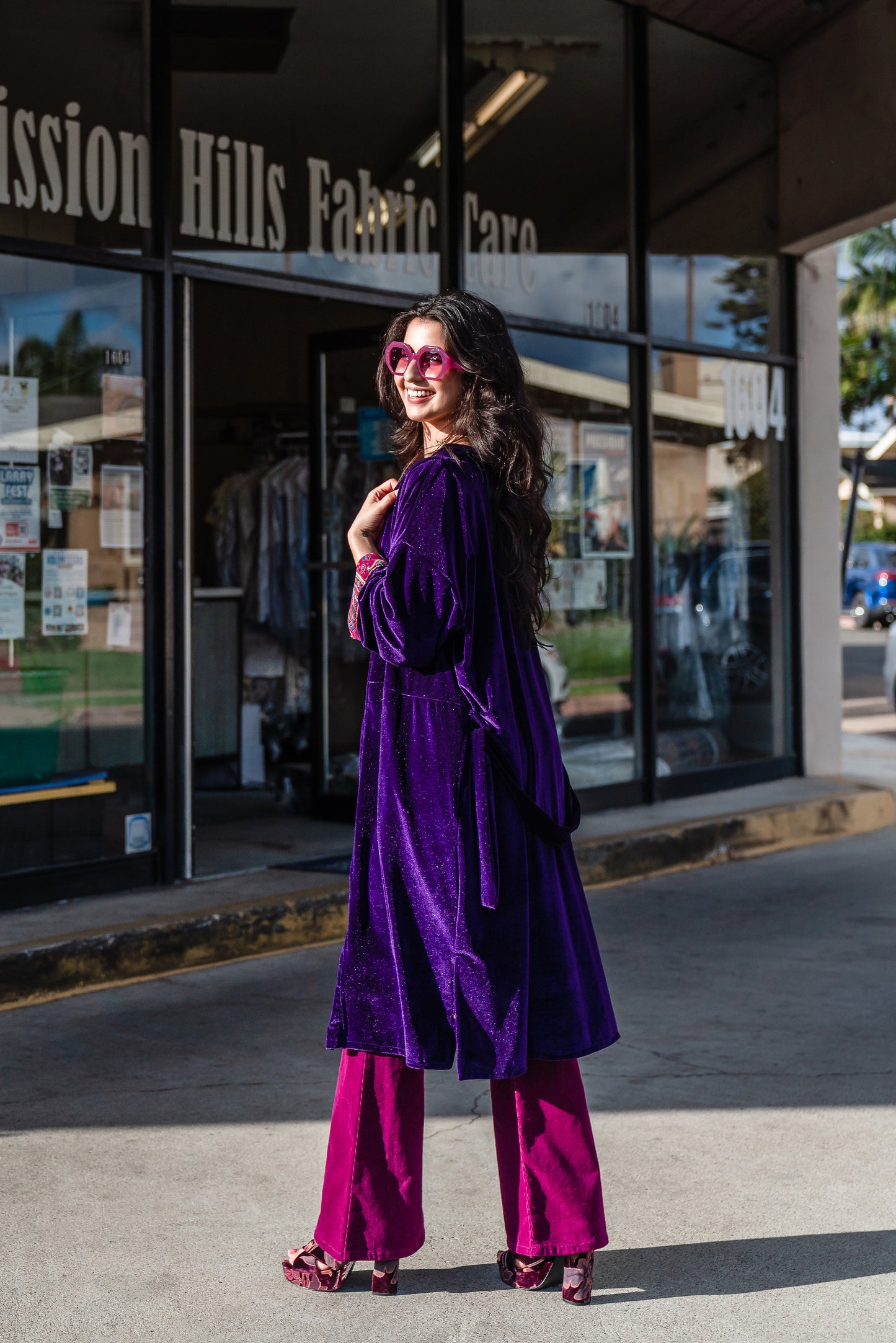 Reversible purple velvet knee length kimono with narrow sleeves, it has tie belt at the waist, the lining is pink and purple paisley printed chiffon, lining is shown at the turned up cuffs