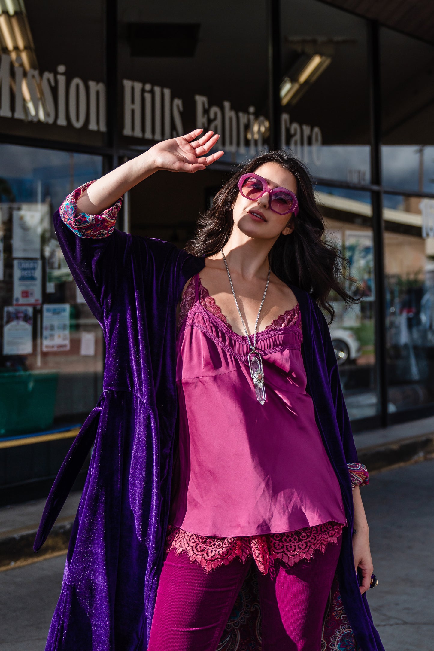 Reversible purple velvet knee length kimono with narrow sleeves, it has tie belt at the waist, the lining is pink and purple paisley printed chiffon, lining is shown at the turned up cuffs