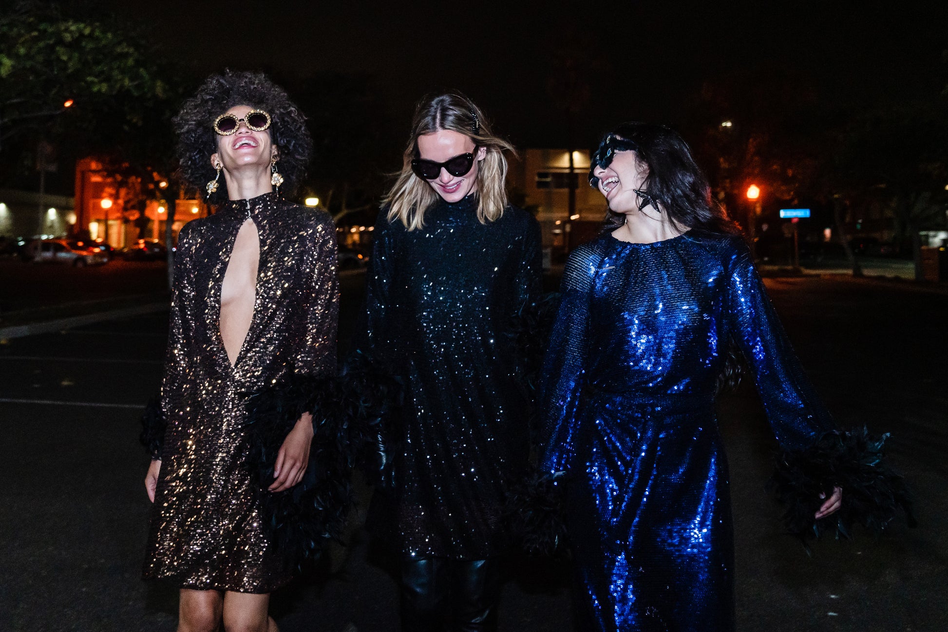 This shimmering copper flash mod mini dress has it all - glittering sequins, delicate mock neck, and long bell sleeves cuffed with black feathers. Retro 60s glam