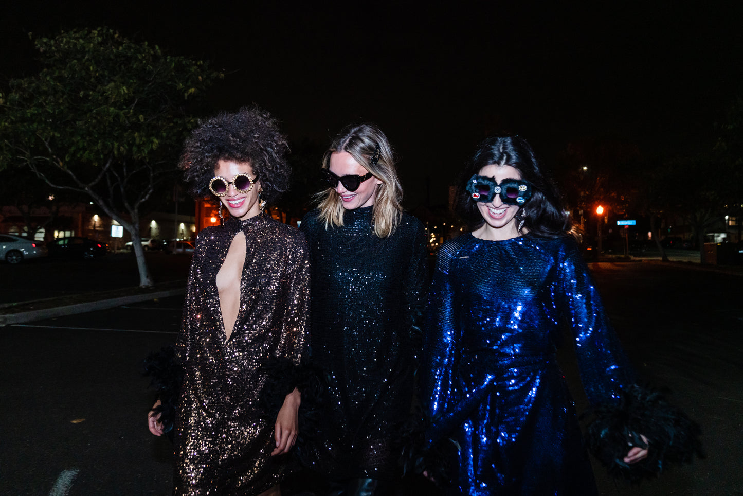 This shimmering copper flash mod mini dress has it all - glittering sequins, delicate mock neck, and long bell sleeves cuffed with black feathers. Retro 60s glam