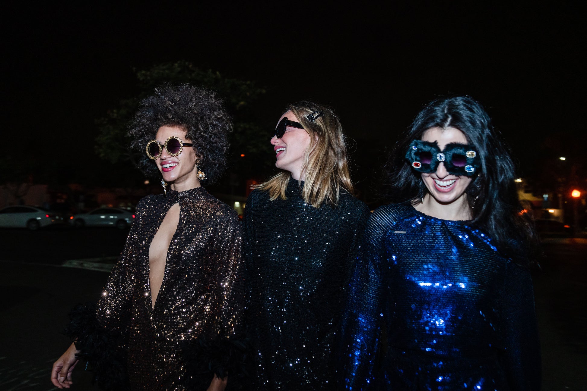 This shimmering black sequin mod mini dress has it all - glittering sequins, delicate mock neck, and long bell sleeves cuffed with black feathers