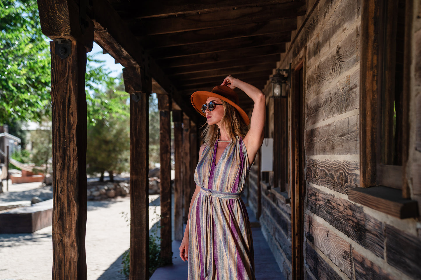 The Vanya dress is free shaped and bohemian, featuring a peek-a-boo neck slit, adjustable shoulder straps, and pockets