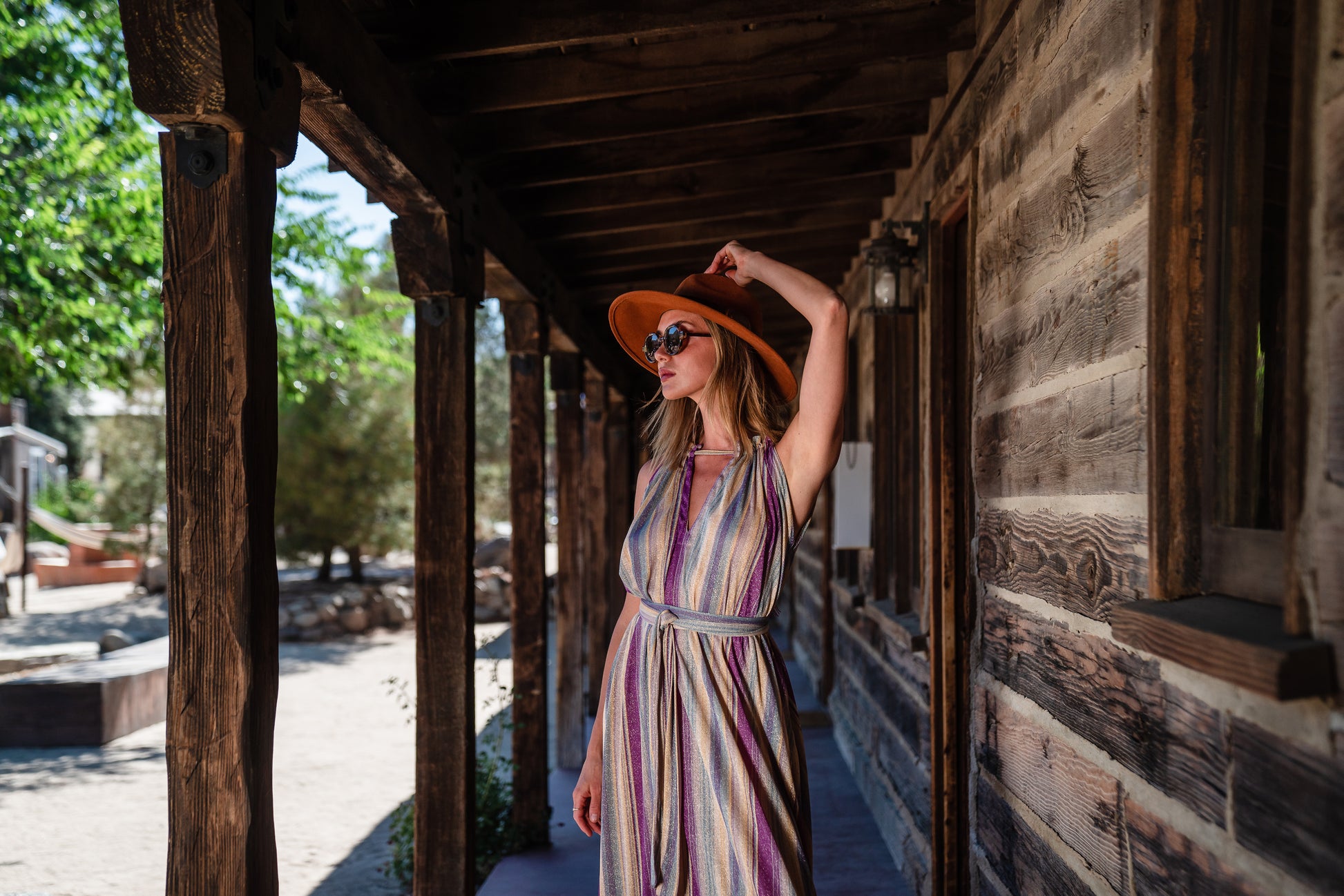 The Vanya dress is free shaped and bohemian, featuring a peek-a-boo neck slit, adjustable shoulder straps, and pockets