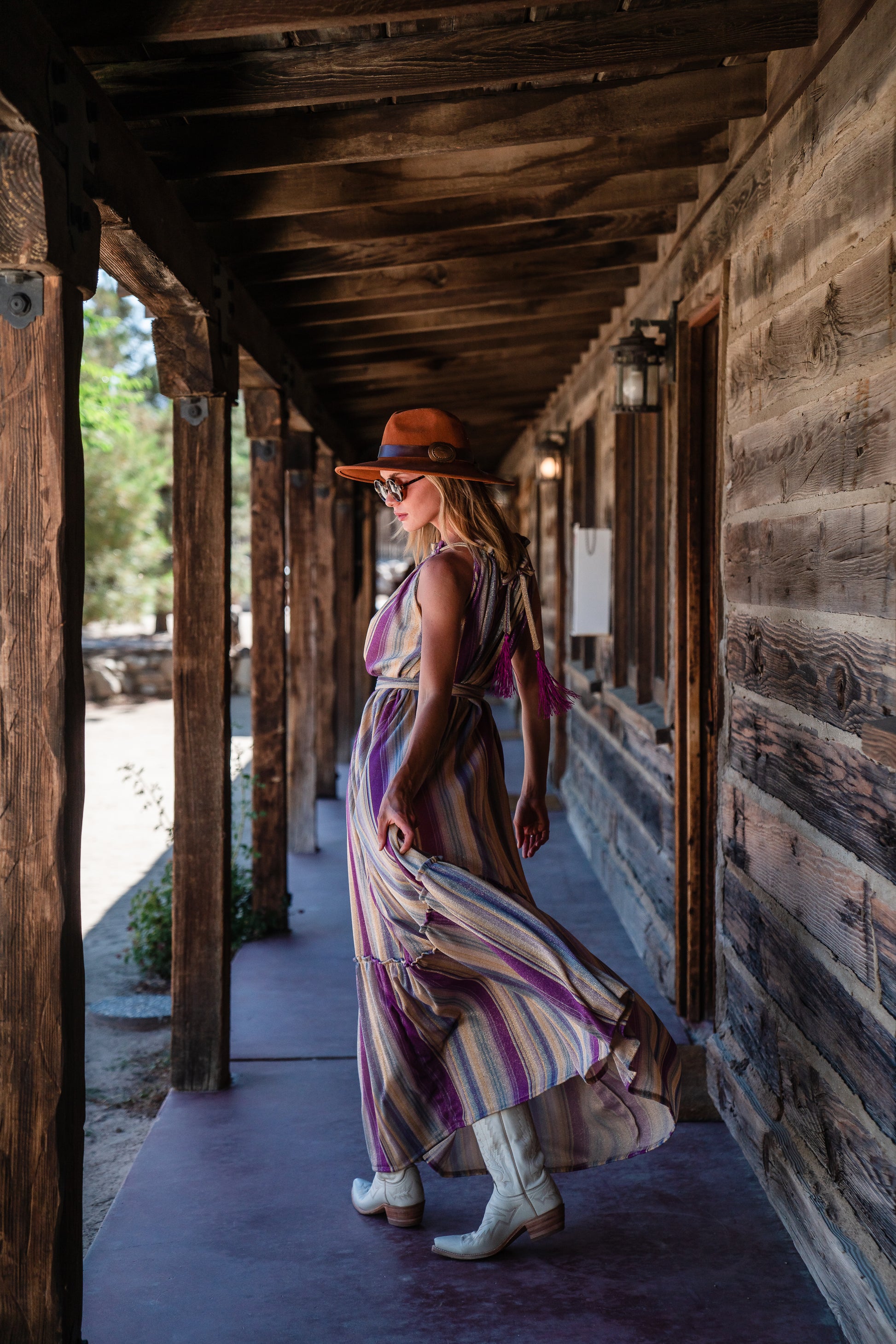 The Vanya dress is free shaped and bohemian, featuring a peek-a-boo neck slit, adjustable shoulder straps, and pockets