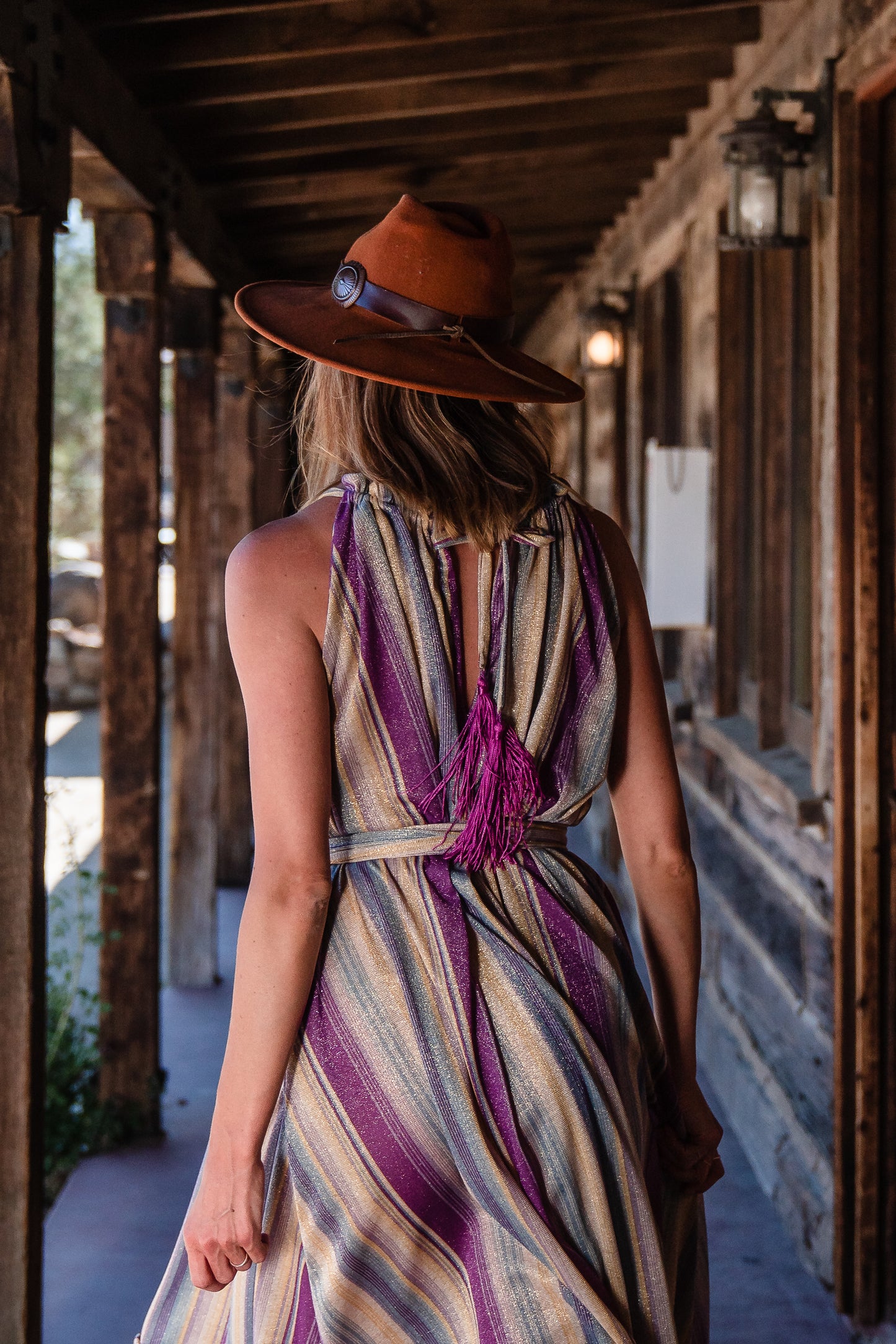 The Vanya dress is free shaped and bohemian, featuring a peek-a-boo neck slit, adjustable shoulder straps, and pockets