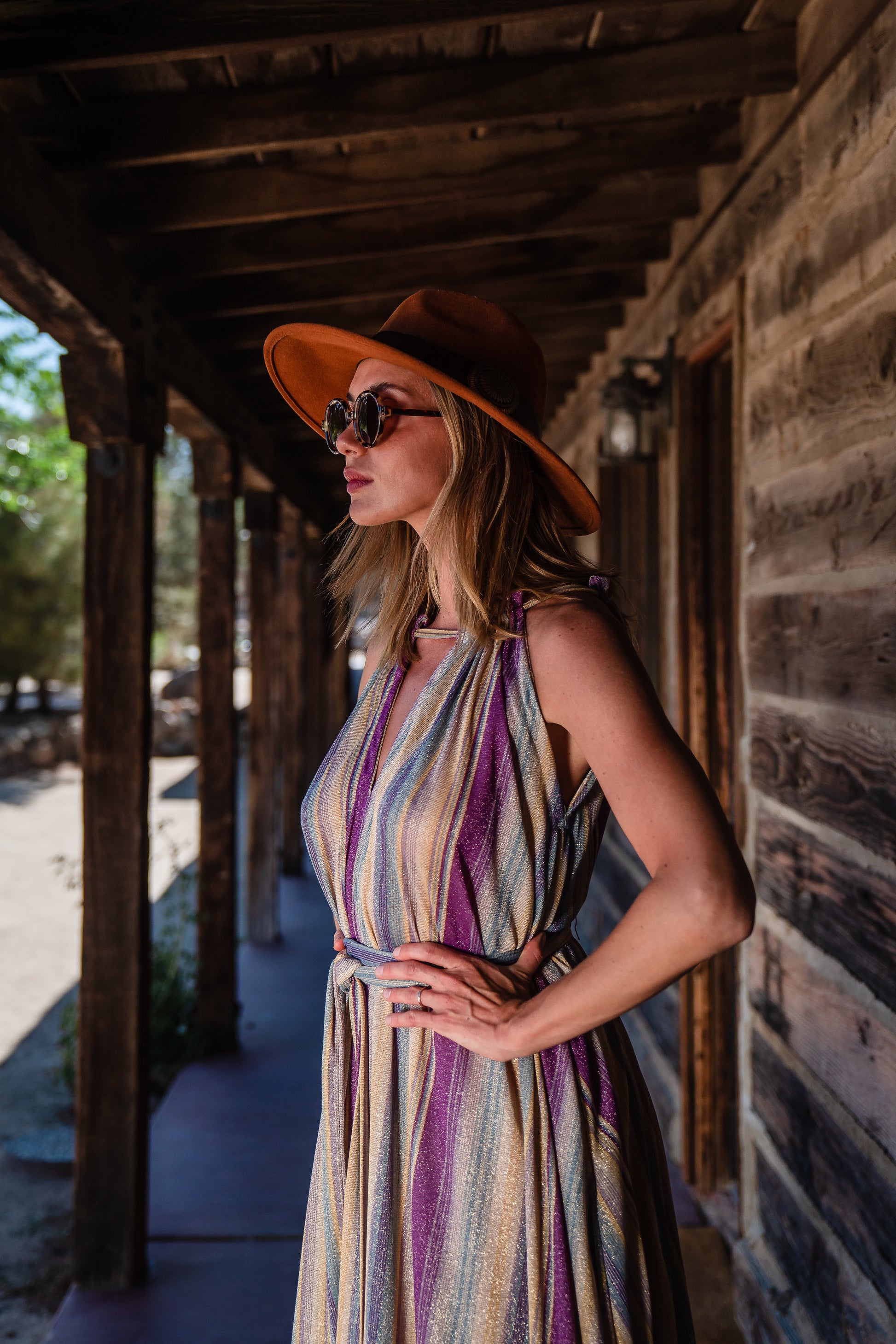 The Vanya dress is free shaped and bohemian, featuring a peek-a-boo neck slit, adjustable shoulder straps, and pockets