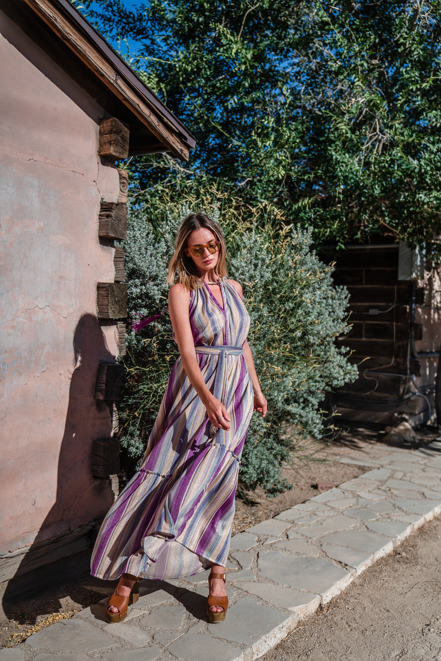 The Vanya dress is free shaped and bohemian, featuring a peek-a-boo neck slit, adjustable shoulder straps, and pockets