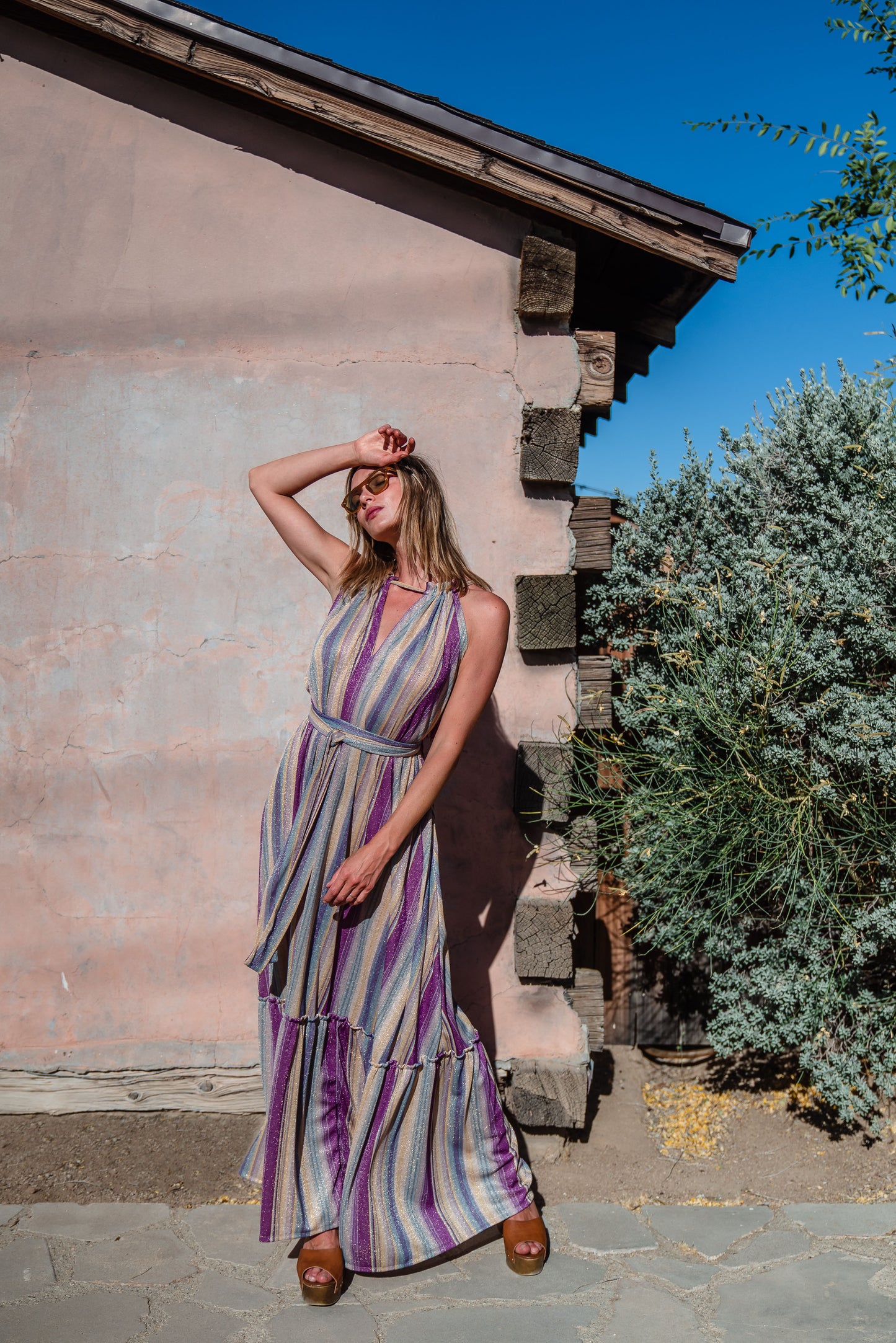 The Vanya dress is free shaped and bohemian, featuring a peek-a-boo neck slit, adjustable shoulder straps, and pockets