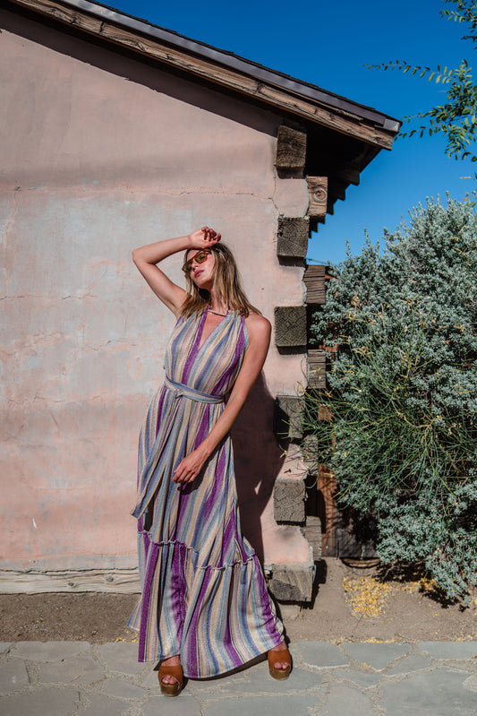 The Vanya dress is free shaped and bohemian, featuring a peek-a-boo neck slit, adjustable shoulder straps, and pockets