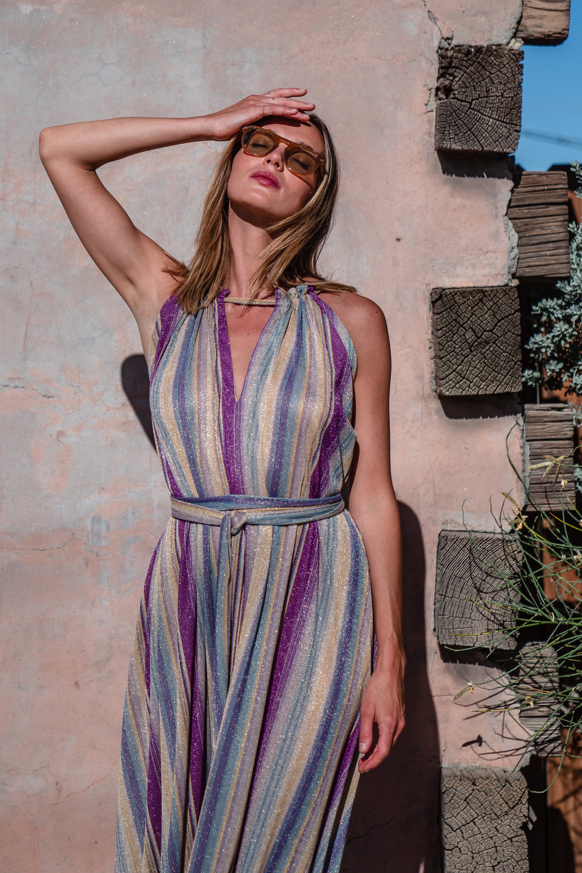 The Vanya dress is free shaped and bohemian, featuring a peek-a-boo neck slit, adjustable shoulder straps, and pockets