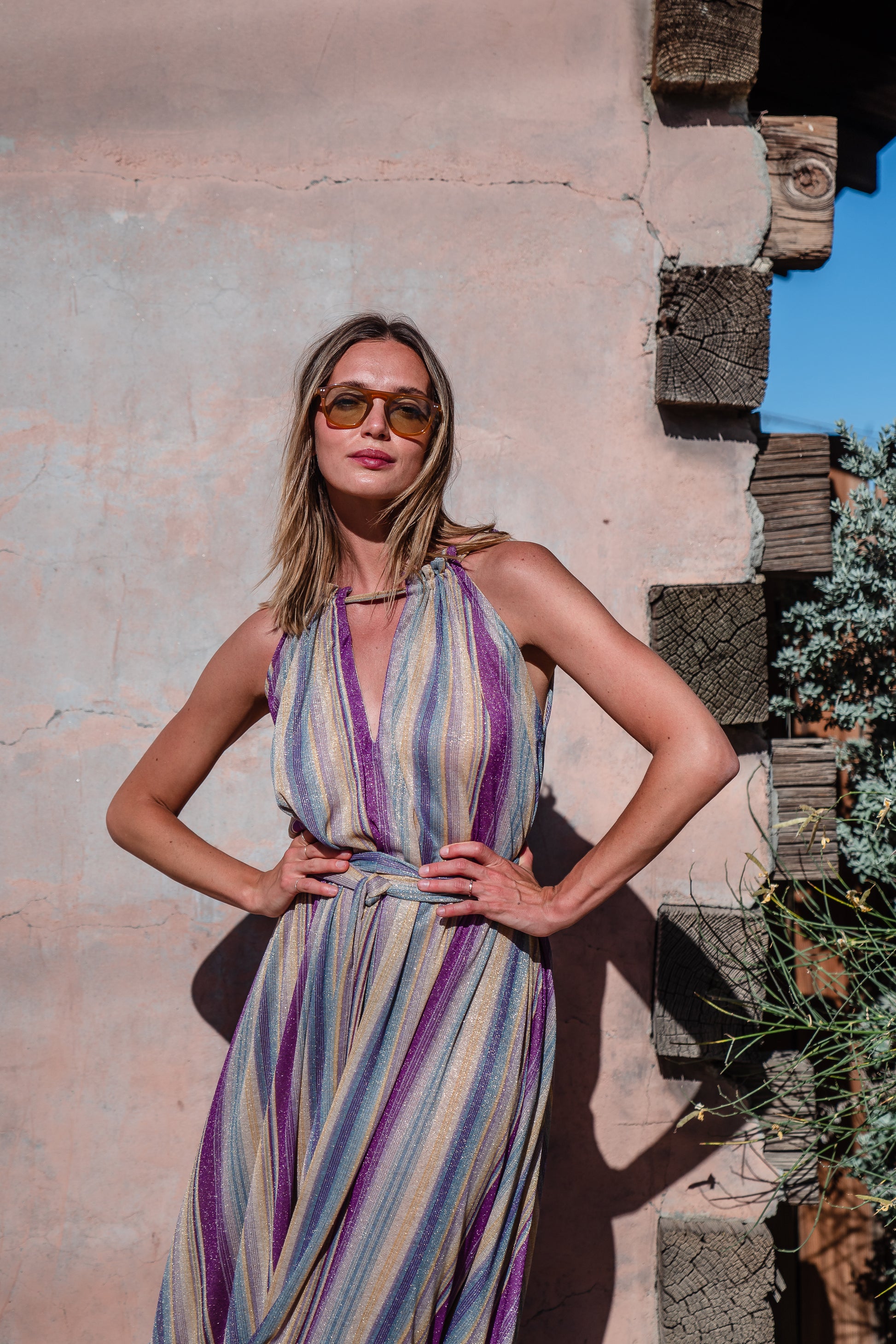 The Vanya dress is free shaped and bohemian, featuring a peek-a-boo neck slit, adjustable shoulder straps, and pockets