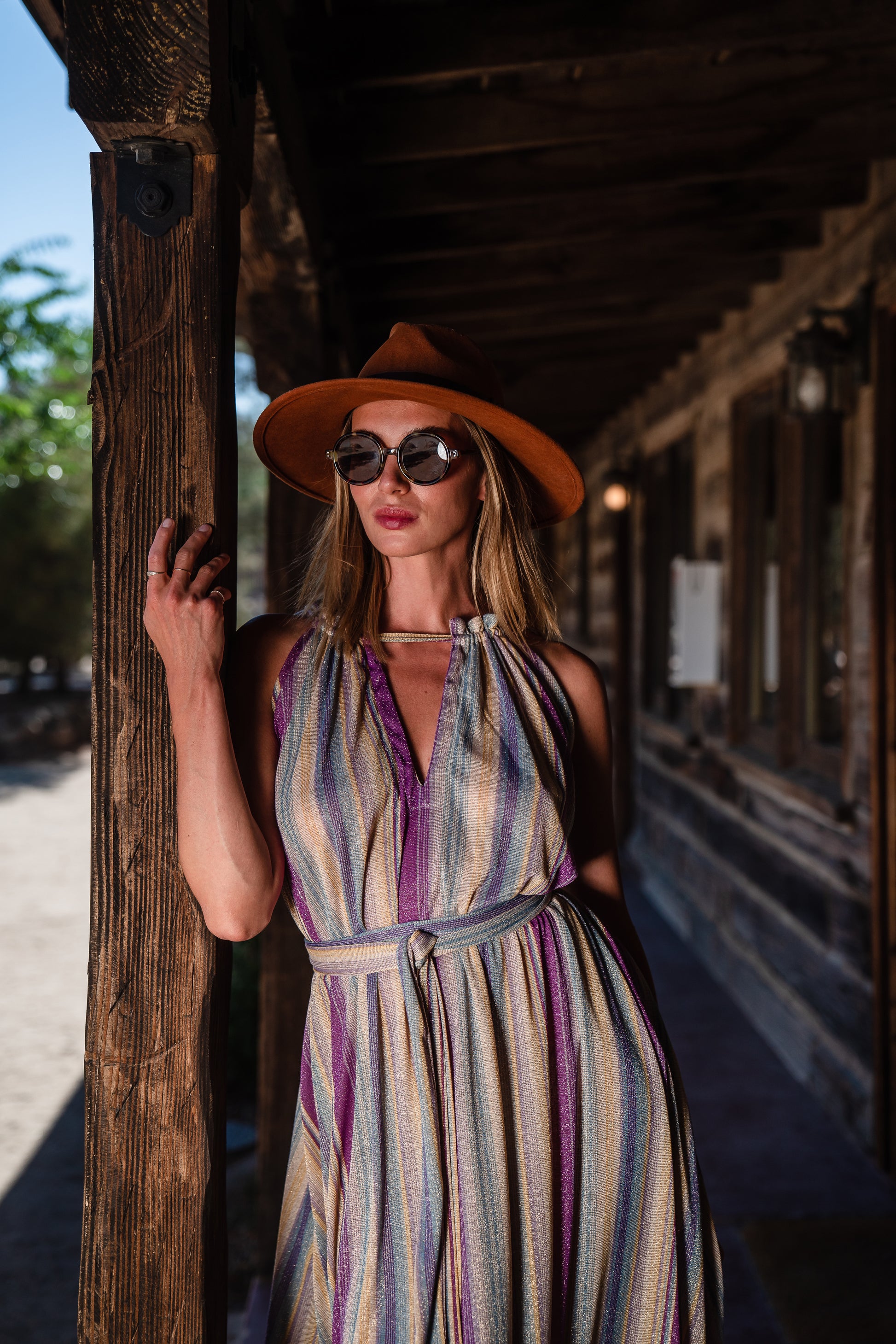 The Vanya dress is free shaped and bohemian, featuring a peek-a-boo neck slit, adjustable shoulder straps, and pockets