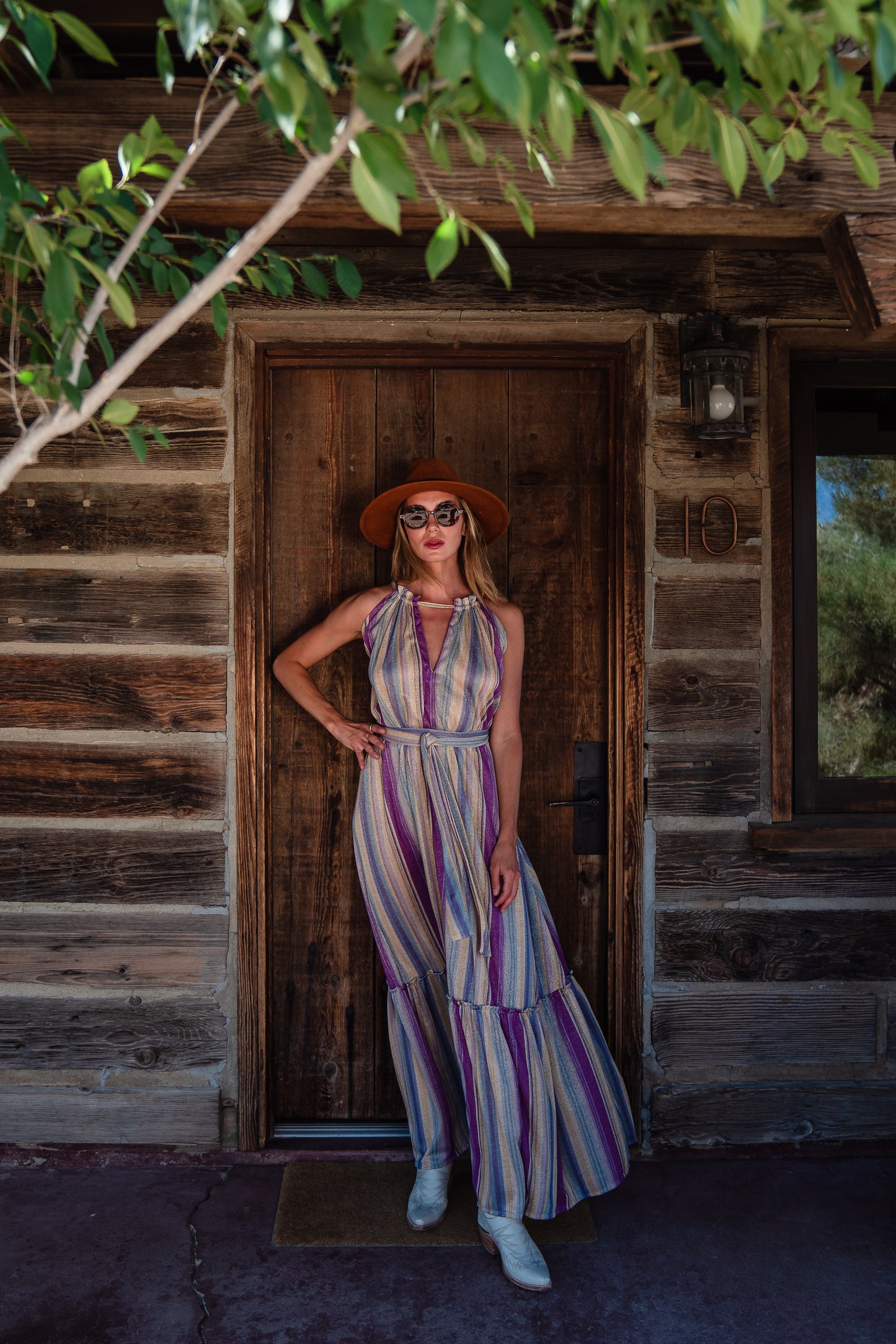The Vanya dress is free shaped and bohemian, featuring a peek-a-boo neck slit, adjustable shoulder straps, and pockets