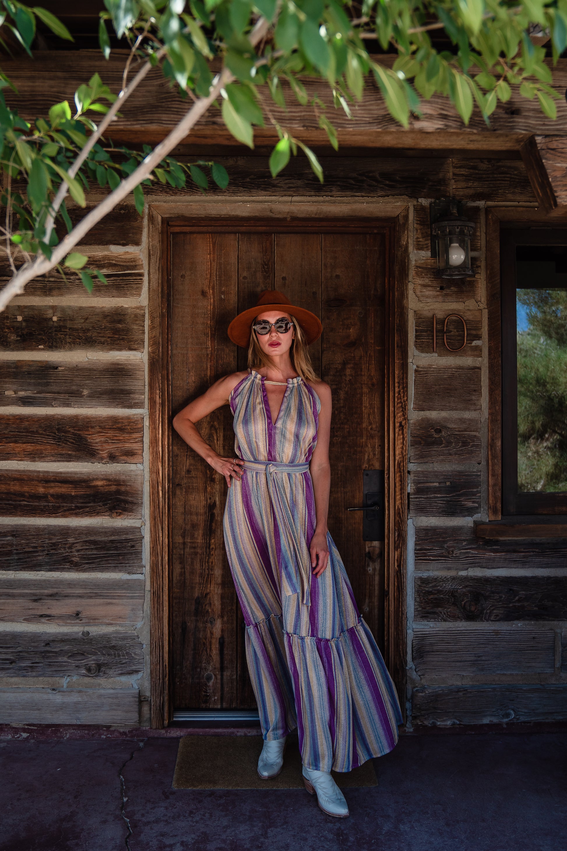 The Vanya dress is free shaped and bohemian, featuring a peek-a-boo neck slit, adjustable shoulder straps, and pockets