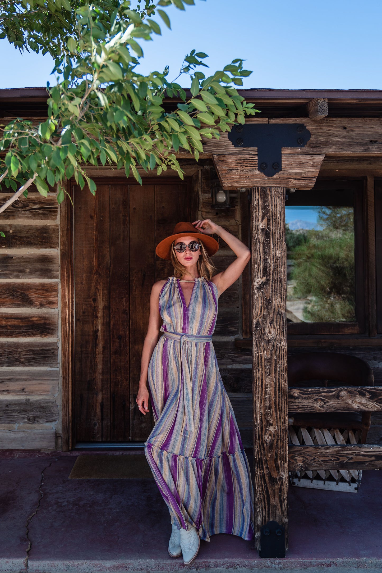 The Vanya dress is free shaped and bohemian, featuring a peek-a-boo neck slit, adjustable shoulder straps, and pockets