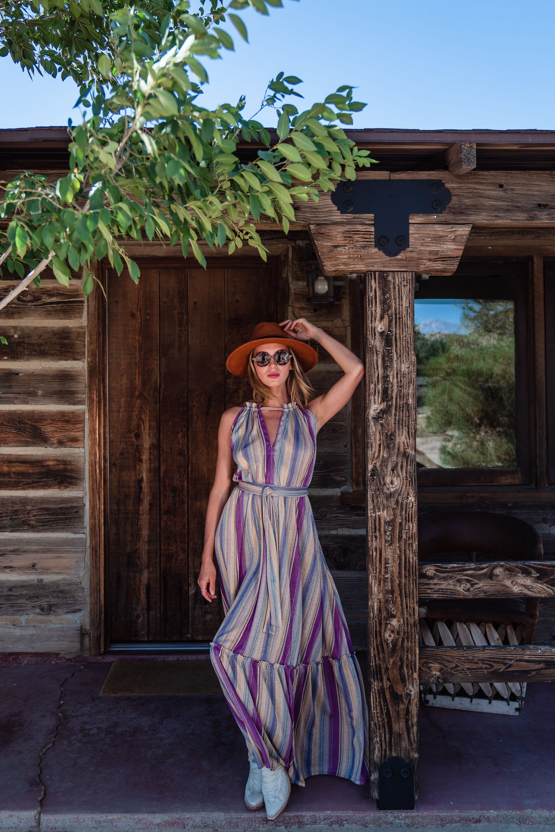 The Vanya dress is free shaped and bohemian, featuring a peek-a-boo neck slit, adjustable shoulder straps, and pockets