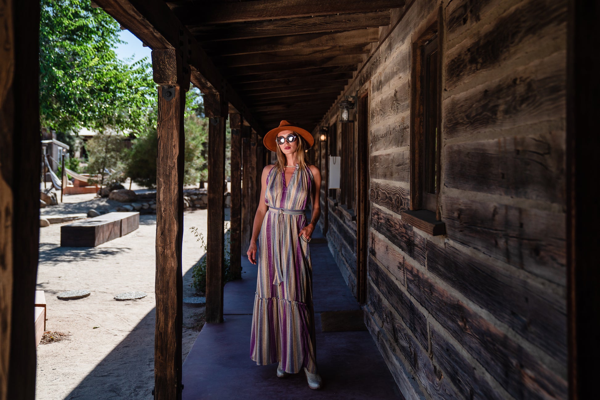 The Vanya dress is free shaped and bohemian, featuring a peek-a-boo neck slit, adjustable shoulder straps, and pockets