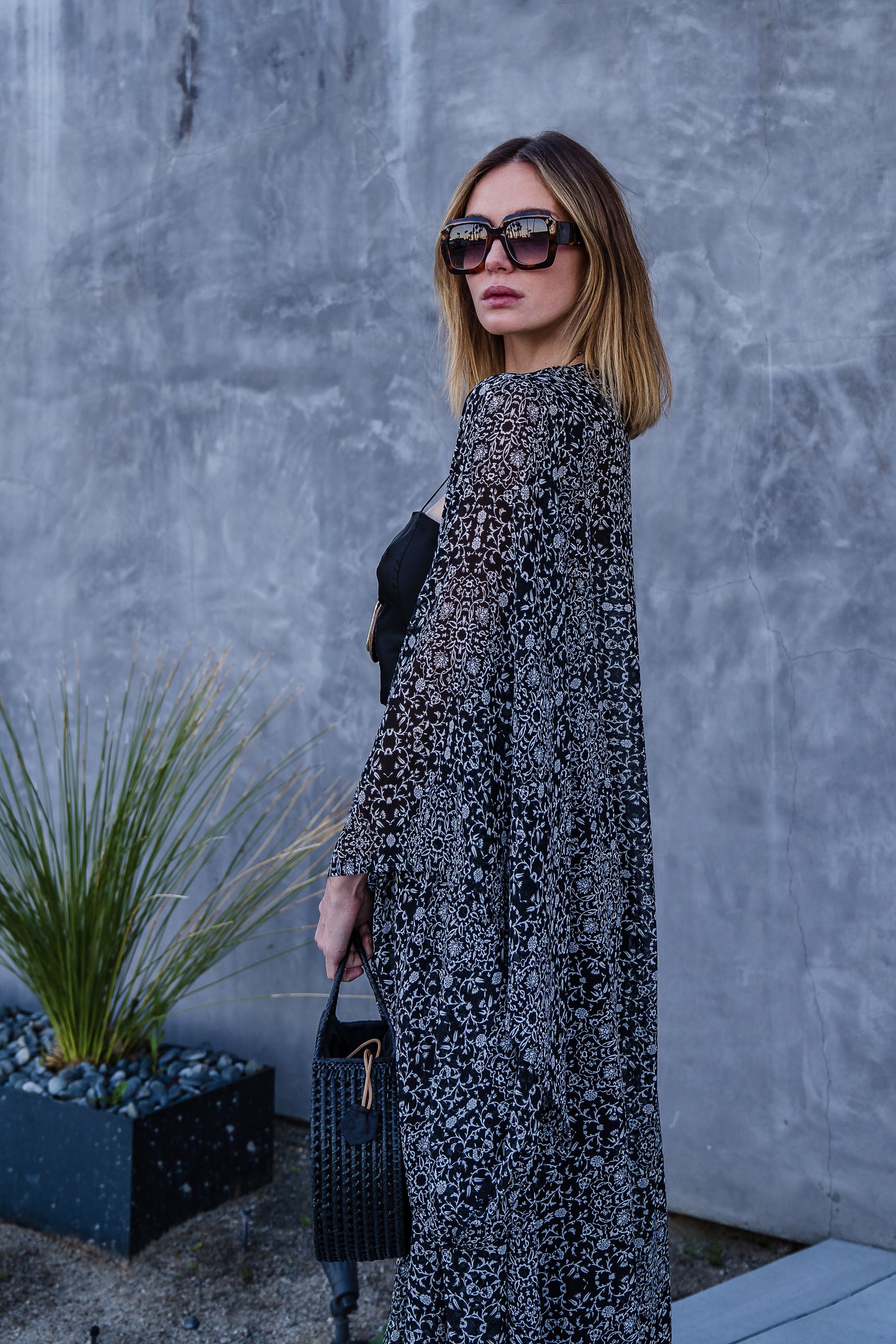 Long sleeve kimono with ankle length hem is made from a soft semi-sheer rayon chiffon. Featuring a black and white victorian floral pattern. It also features pockets, deep v-neck when tied shut, and a matching waist tie-you can style this piece in at least 10 ways.