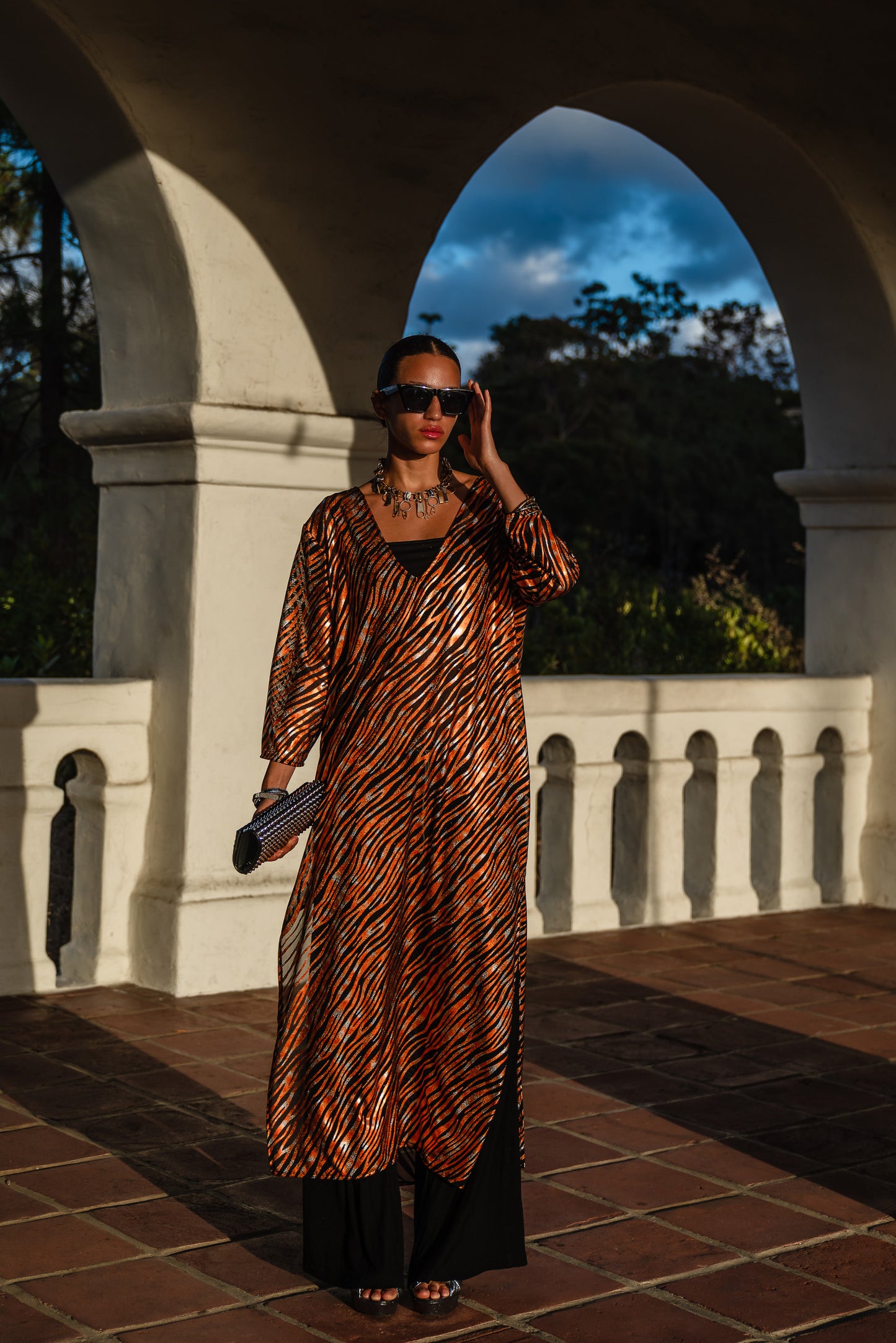 Gold foiled zebra Printed calf length caftan, with sleeves, a v-neck and splits up the side seams to the mid thigh