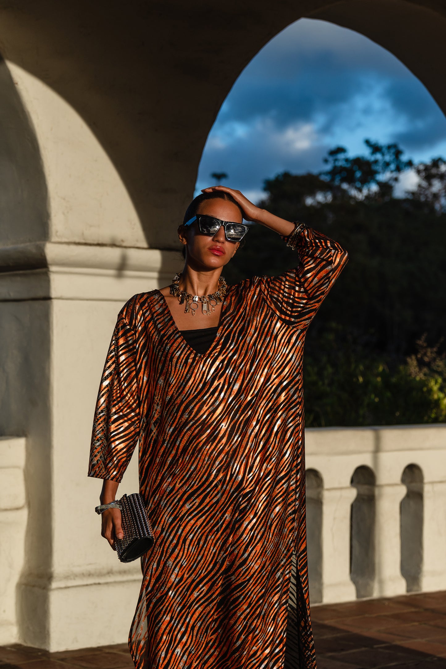 Gold foiled zebra Printed calf length caftan, with sleeves, a v-neck and splits up the side seams to the mid thigh
