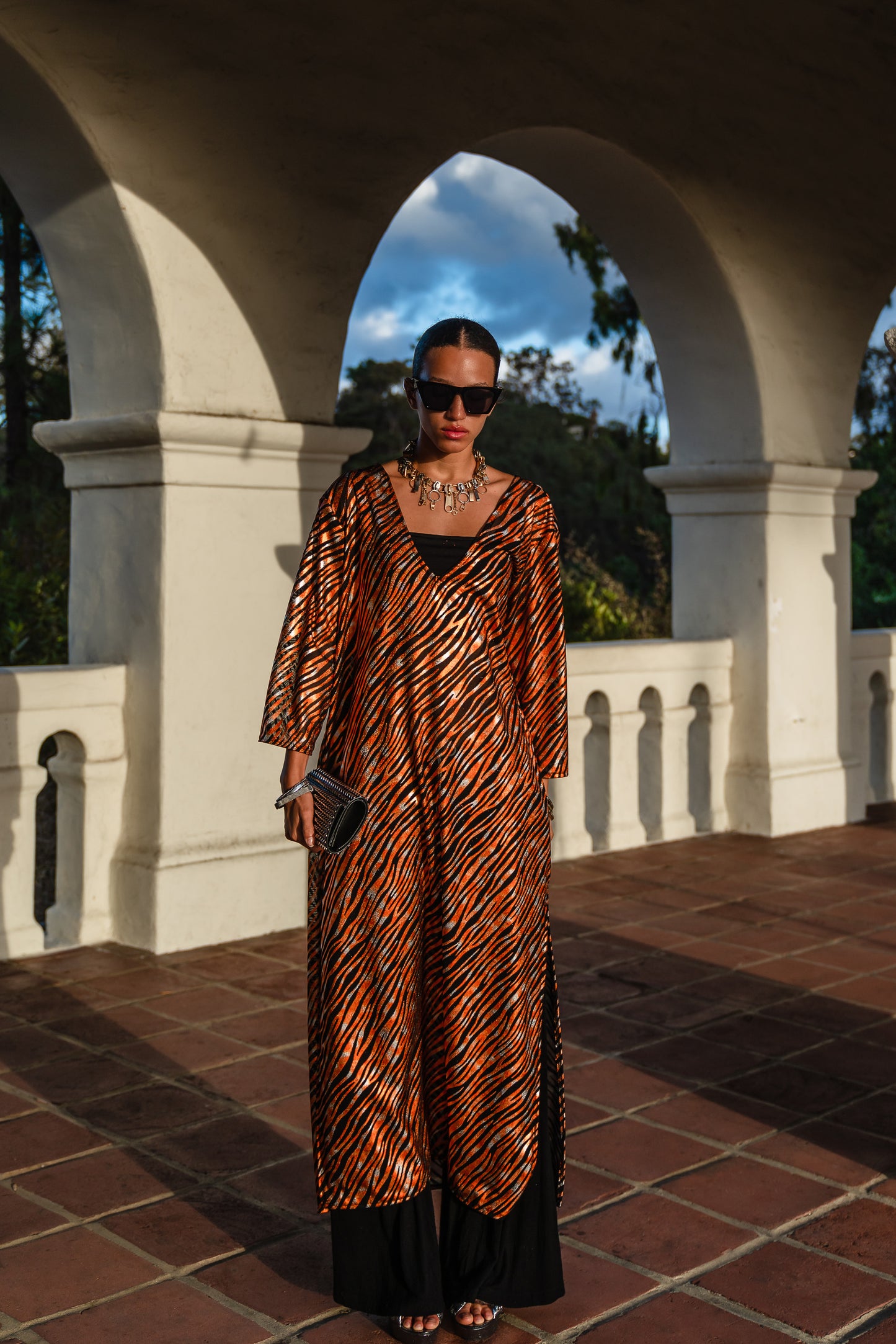 Gold foiled zebra Printed calf length caftan, with sleeves, a v-neck and splits up the side seams to the mid thigh