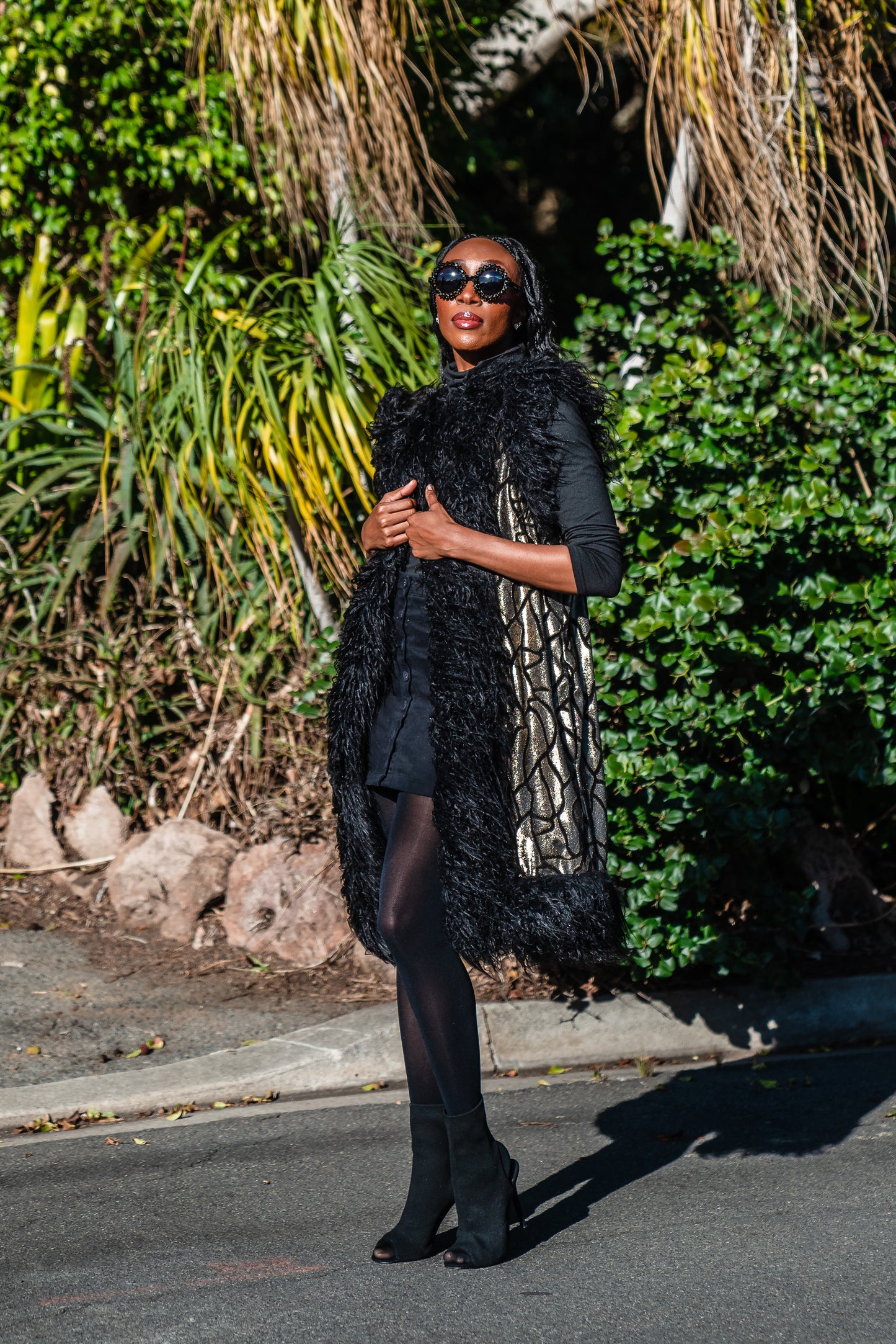 Fur Trim Vest made of shining gold waxed velvet and trimmed with black Mongolian fur. Sleeveless with knee length hem.